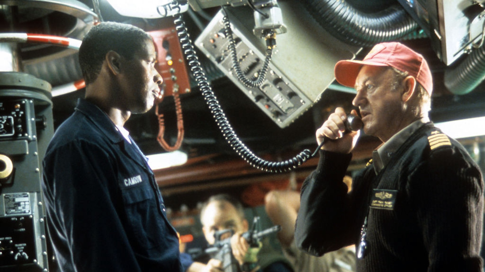 Gene Hackman and Denzel Washington being held at gun point in the control room in a scene from the film 'Crimson Tide', 1995.