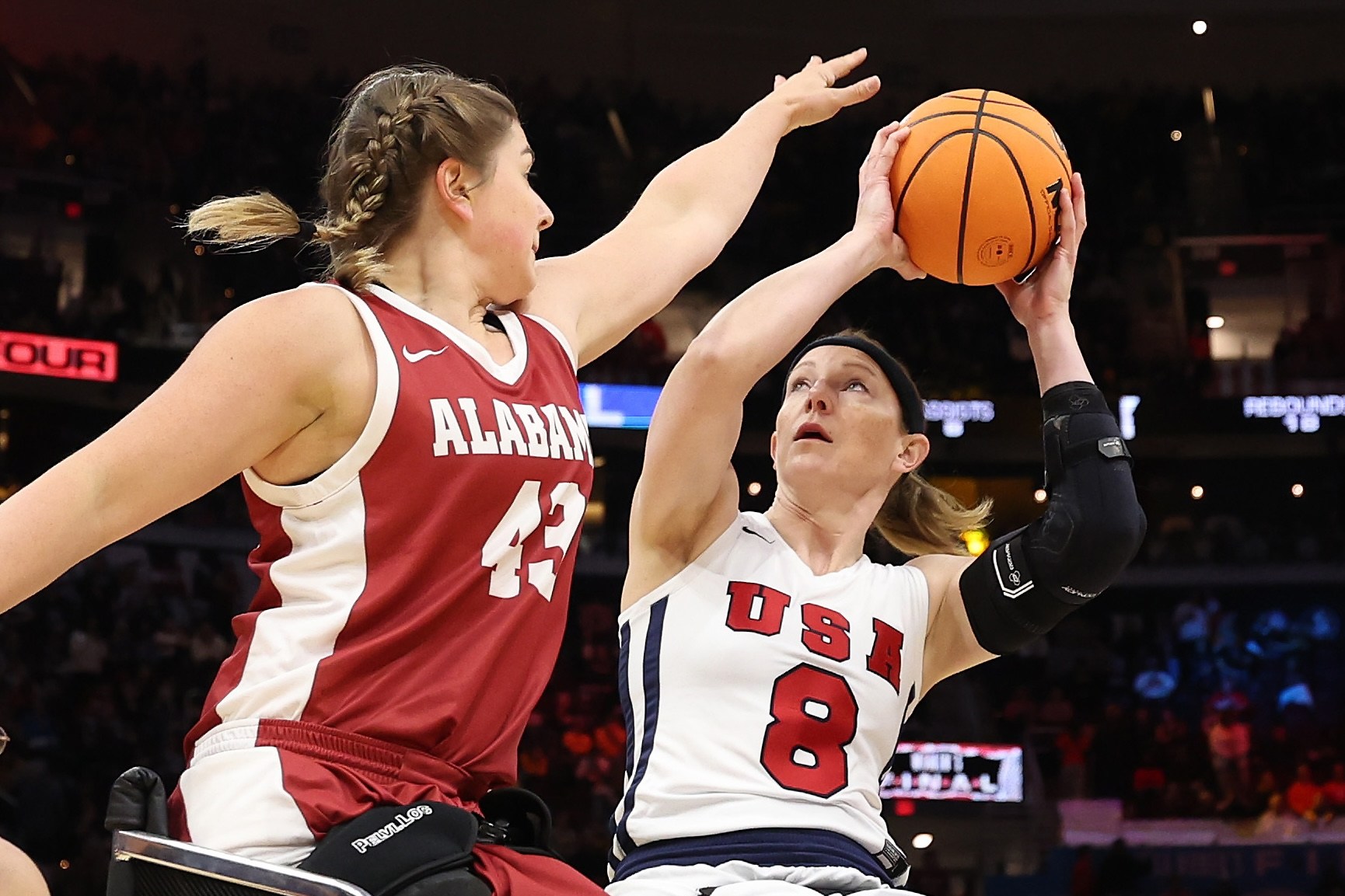 CLEVELAND, OHIO - APRIL 07: Wheelchair basketball athletes Natalie Schneider of Team USA, Zoie Voris of the Arlington Lady Movin' Mavs, Hayley Nielsen #20 of Arizona and and Josie Aslakson #7 of Team USA compete at halftime during the 2024 NCAA Women's Basketball Tournament National Championship between the Iowa Hawkeyes and South Carolina Gamecocks at Rocket Mortgage FieldHouse on April 07, 2024 in Cleveland, Ohio. (Photo by Steph Chambers/Getty Images)