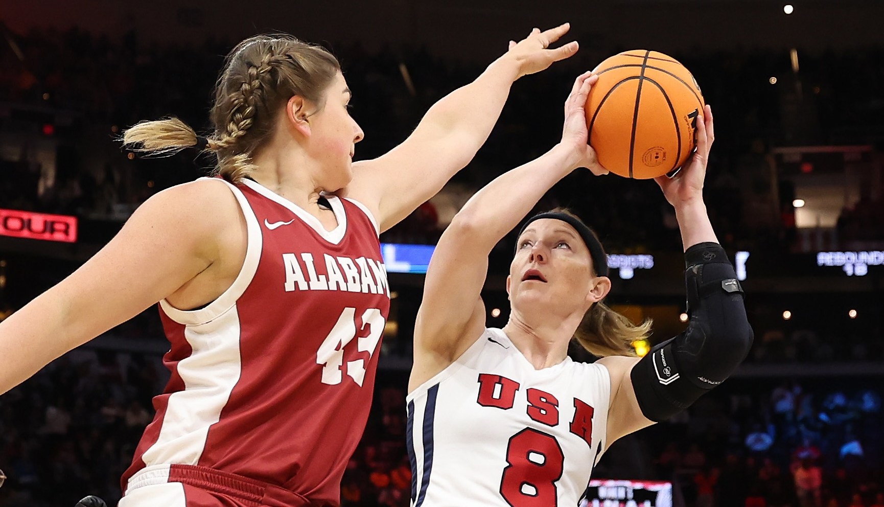 CLEVELAND, OHIO - APRIL 07: Wheelchair basketball athletes Natalie Schneider of Team USA, Zoie Voris of the Arlington Lady Movin' Mavs, Hayley Nielsen #20 of Arizona and and Josie Aslakson #7 of Team USA compete at halftime during the 2024 NCAA Women's Basketball Tournament National Championship between the Iowa Hawkeyes and South Carolina Gamecocks at Rocket Mortgage FieldHouse on April 07, 2024 in Cleveland, Ohio. (Photo by Steph Chambers/Getty Images)