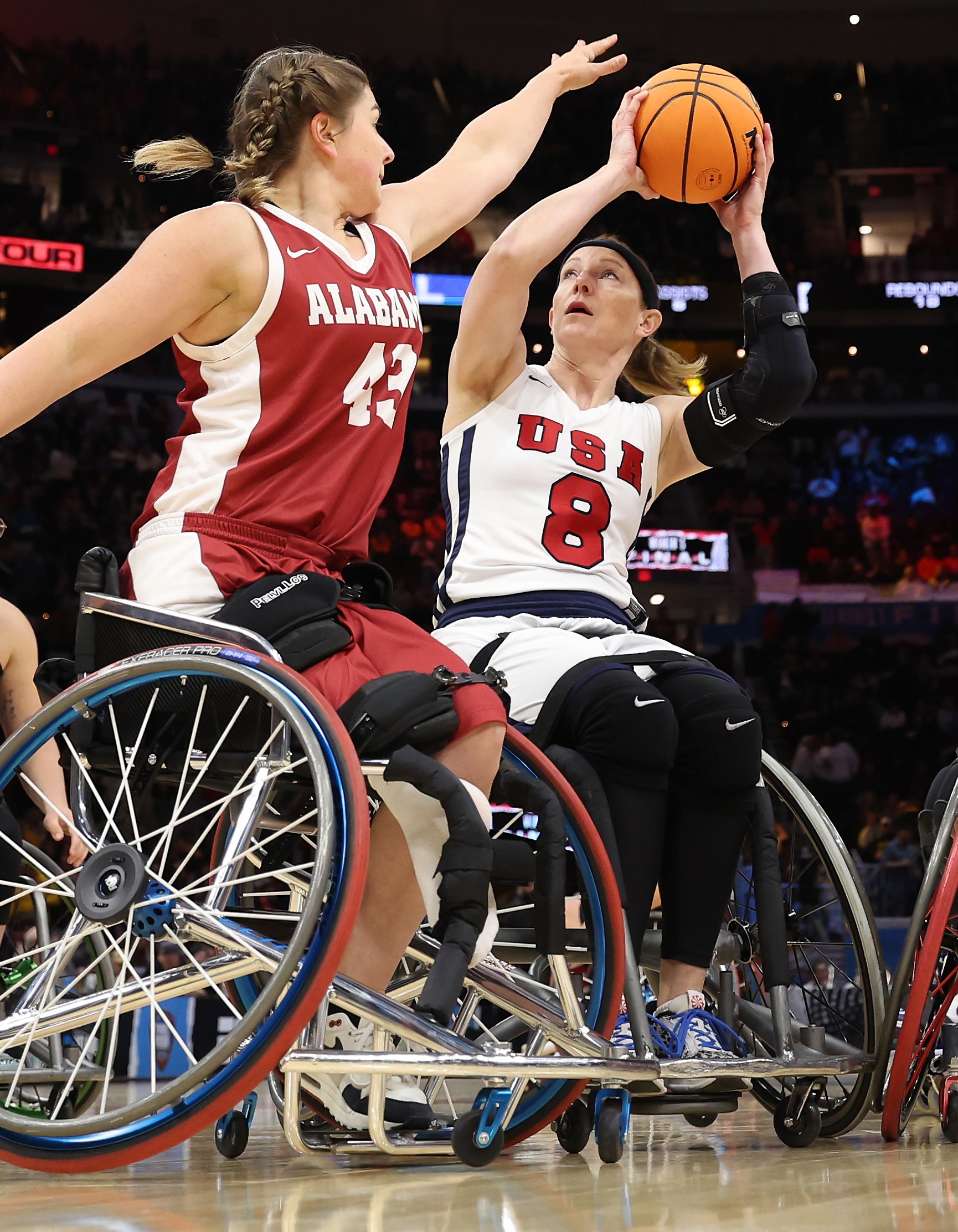 CLEVELAND, OHIO - APRIL 07: Wheelchair basketball athletes Natalie Schneider of Team USA, Zoie Voris of the Arlington Lady Movin' Mavs, Hayley Nielsen #20 of Arizona and and Josie Aslakson #7 of Team USA compete at halftime during the 2024 NCAA Women's Basketball Tournament National Championship between the Iowa Hawkeyes and South Carolina Gamecocks at Rocket Mortgage FieldHouse on April 07, 2024 in Cleveland, Ohio. (Photo by Steph Chambers/Getty Images)