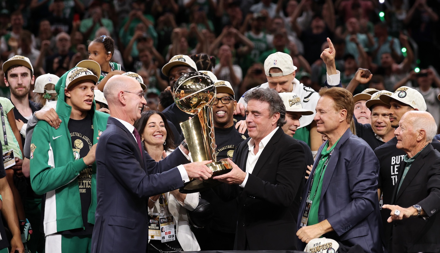 BOSTON, MASSACHUSETTS - JUNE 17: NBA Commissioner Adam Silver hands majority owner Wyc Grousbeck of the Boston Celtics the Larry O’Brien Championship Trophy after Boston's 106-88 win against the Dallas Mavericks in Game Five of the 2024 NBA Finals at TD Garden on June 17, 2024 in Boston, Massachusetts. NOTE TO USER: User expressly acknowledges and agrees that, by downloading and or using this photograph, User is consenting to the terms and conditions of the Getty Images License Agreement. (Photo by Elsa/Getty Images)