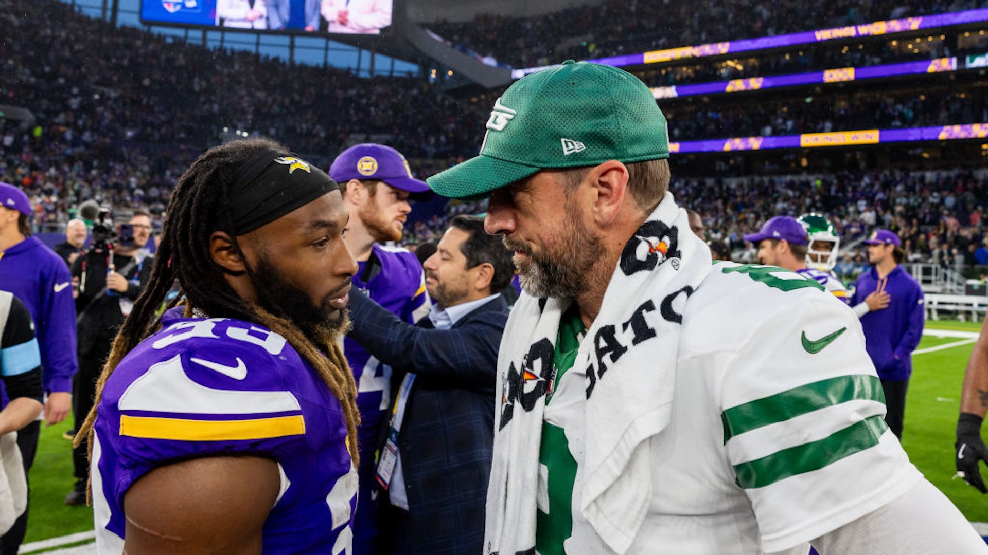 New York Jets quarterback Aaron Rodgers (8) talks with former teammate Minnesota Vikings running back Aaron Jones (33) after the professional NFL football game between the New York Jets and Minnesota Vikings on October 6, 2024 at Tottenham Hotspur Stadium in London, England.