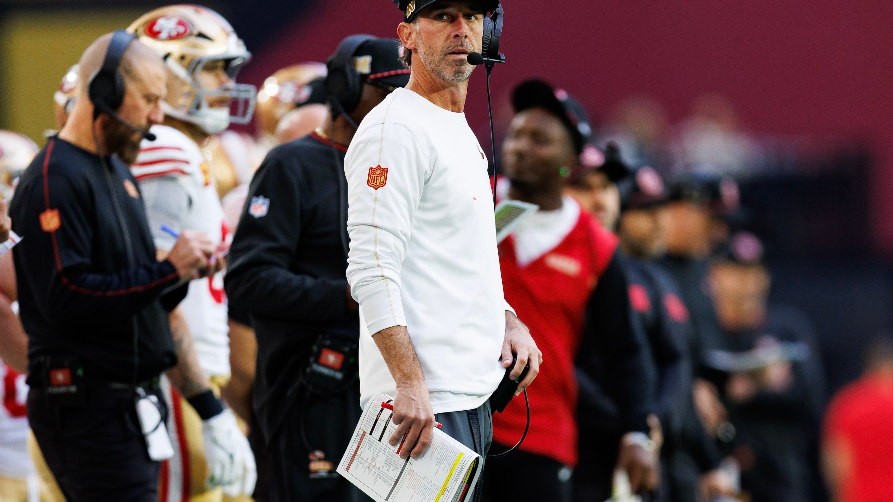 Head coach Kyle Shanahan of the San Francisco 49ers stands on the sidelines during the first half of an NFL football game against the Arizona Cardinals in January of 2025.