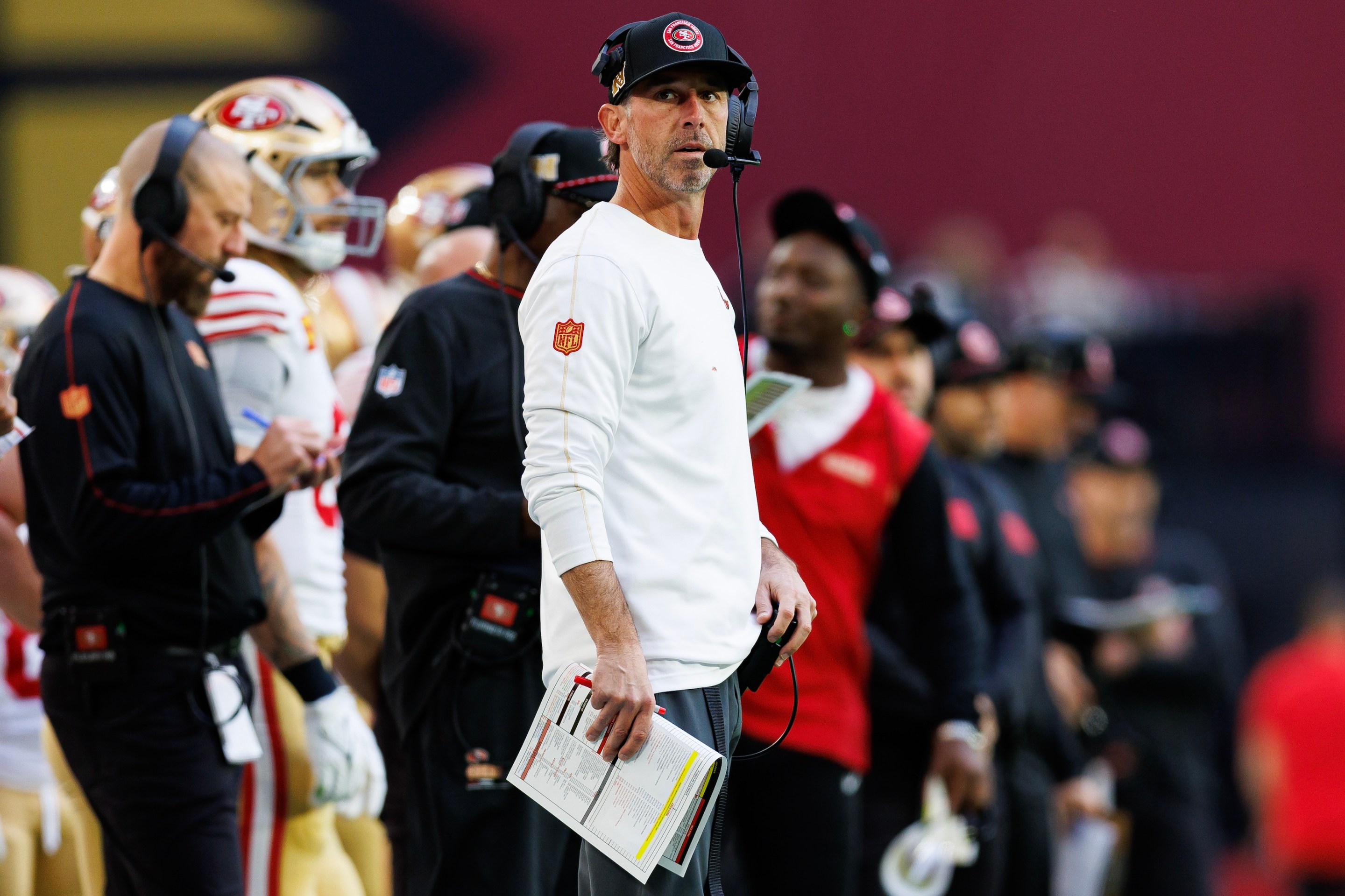 Head coach Kyle Shanahan of the San Francisco 49ers stands on the sidelines during the first half of an NFL football game against the Arizona Cardinals in January of 2025.