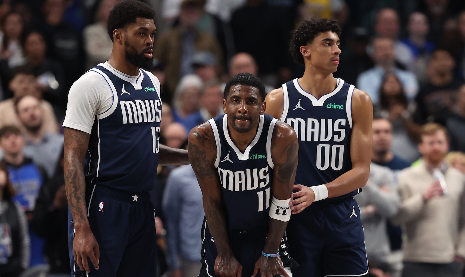 DALLAS, TEXAS - MARCH 03: (L-R) Naji Marshall #13, Kyrie Irving #11 and Max Christie #00 of the Dallas Mavericks pause during the first half against the Sacramento Kings at American Airlines Center on March 03, 2025 in Dallas, Texas. NOTE TO USER: User expressly acknowledges and agrees that, by downloading and/or using this photograph, user is consenting to the terms and conditions of the Getty Images License Agreement. (Photo by Sam Hodde/Getty Images)