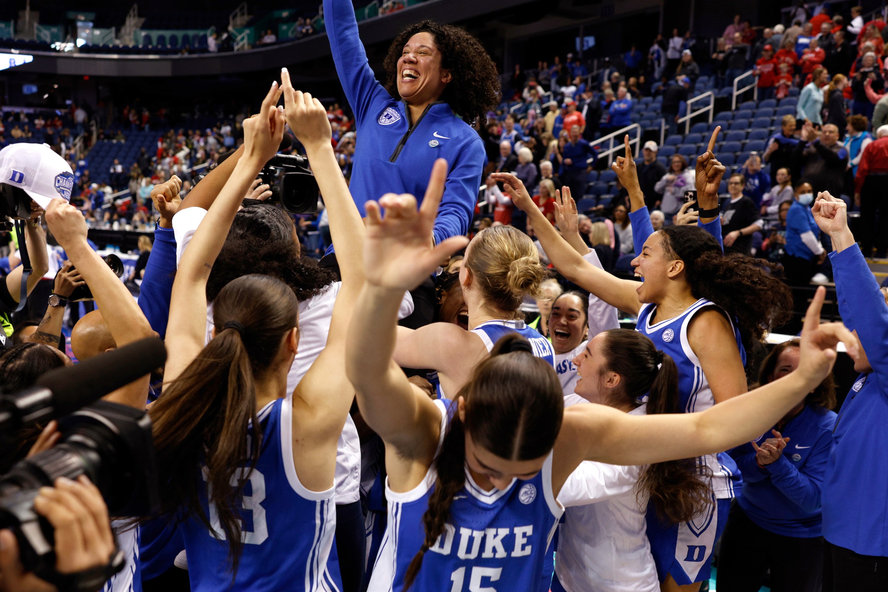 Head coach Kara Lawson of the Duke Blue Devils celebrates with her team following their victory against the NC State Wolfpack in the championship game of the ACC women's basketball tournament at First Horizon Coliseum on March 9, 2025 in Greensboro, North Carolina.