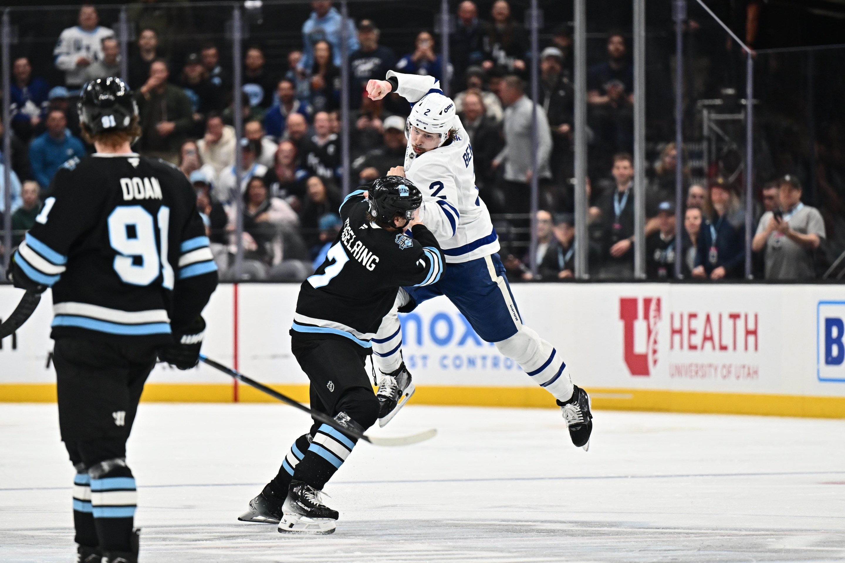 SALT LAKE CITY, UTAH - MARCH 10: Simon Benoit #2 of the Toronto Maple Leafs fights against Michael Kesselring #7 of the Utah Hockey Club during the second period of a game on March 10, 2025 at Delta Center in Salt Lake City, Utah. (Photo by Jamie Sabau/NHLI via Getty Images)