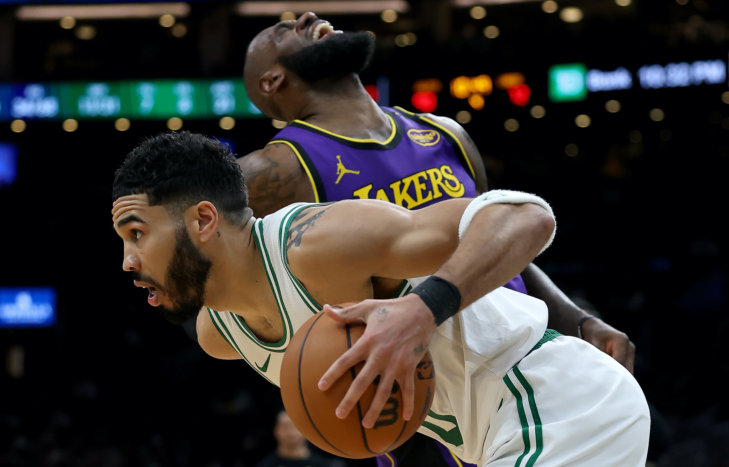 Jayson Tatum drives on LeBron James