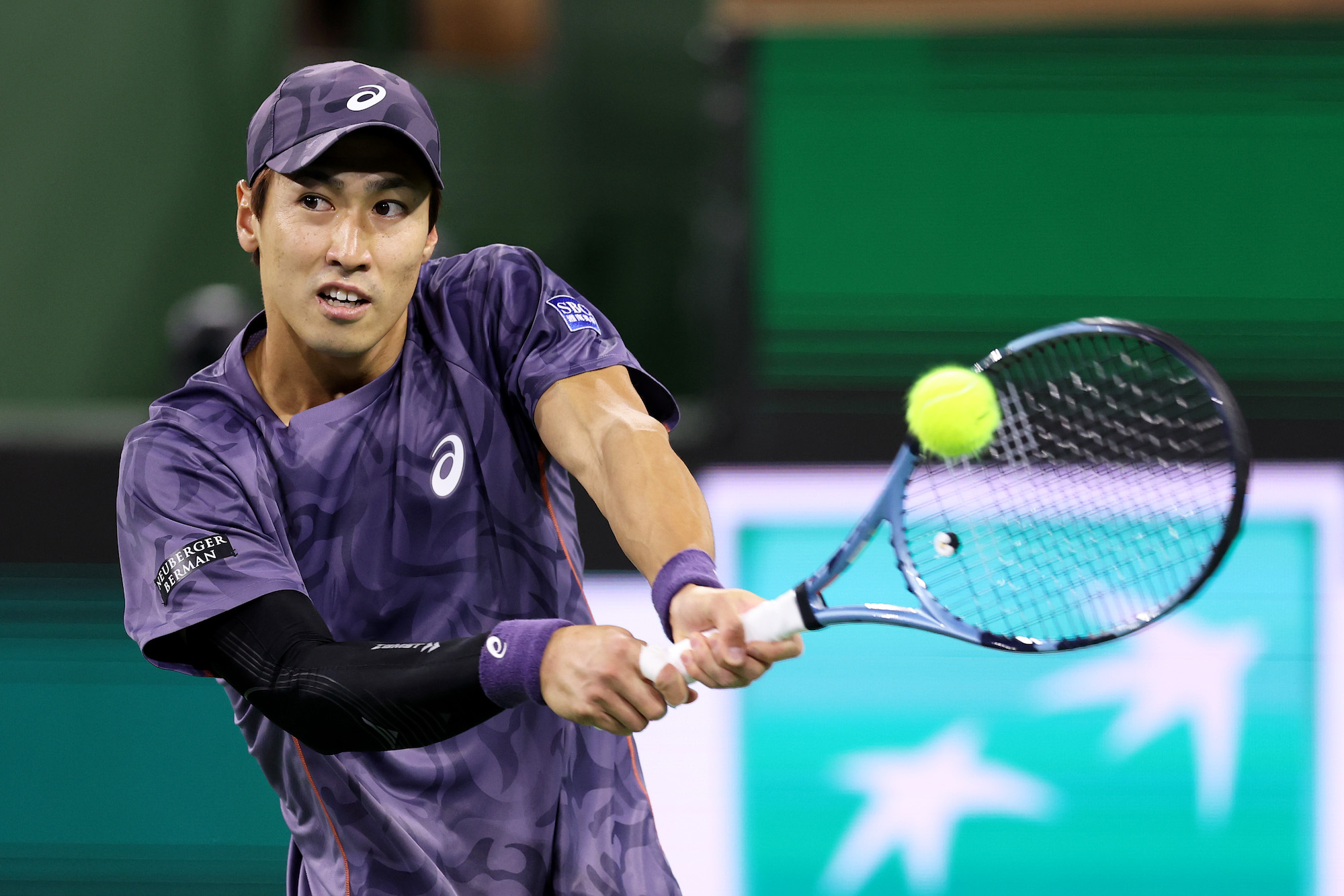 Yosuke Watanuki of Japan plays a backhand against Frances Tiafoe of the United States in their third round match during the BNP Paribas Open at Indian Wells Tennis Garden on March 09, 2025 in Indian Wells, California. (Photo by Clive Brunskill/Getty Images)