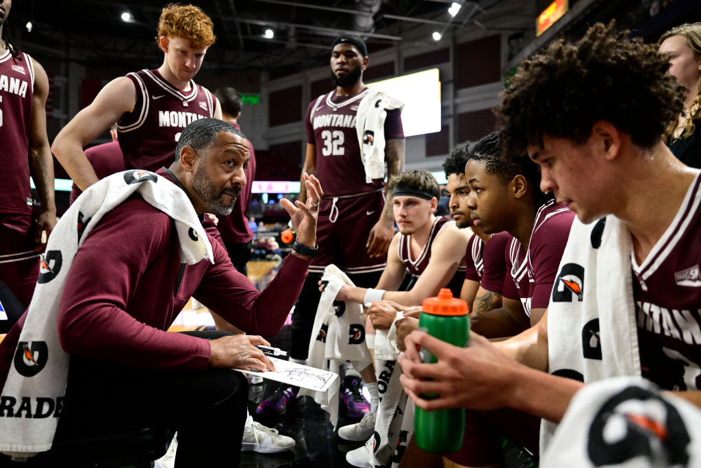 Head coach Travis DeCuire of the Montana Grizzlies talks with the team during a time out against the Northern Colorado Bears the Big Sky Conference Championshi