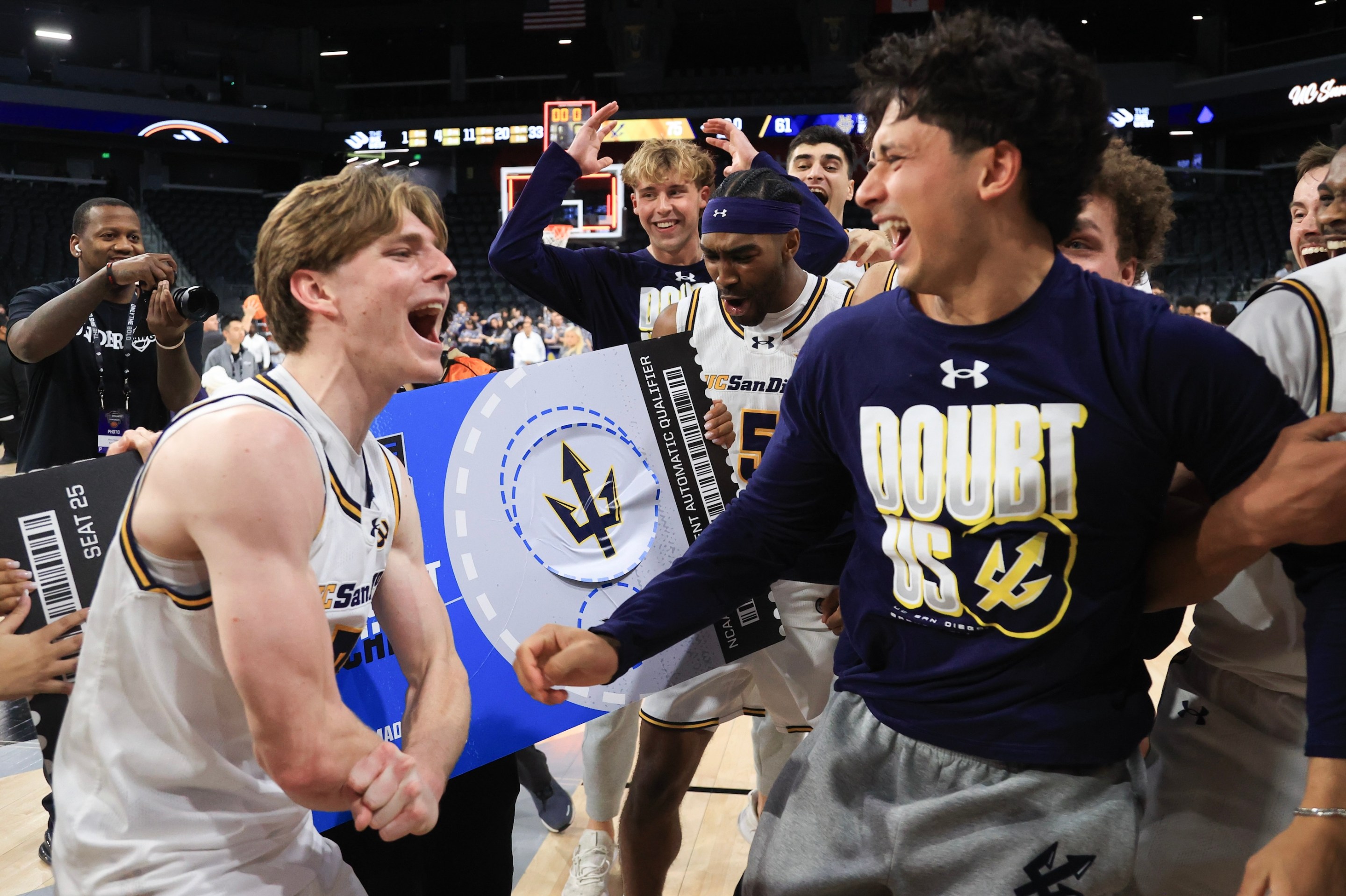 Hayden Gray #3, Justin Rochelin #5, and Yaqub Mir #22 of the UC San Diego Tritons celebrate after their team's 75-61 victory against the UC Irvine Anteaters to win the Big West Men's Basketball Tournament on March 15, 2025.