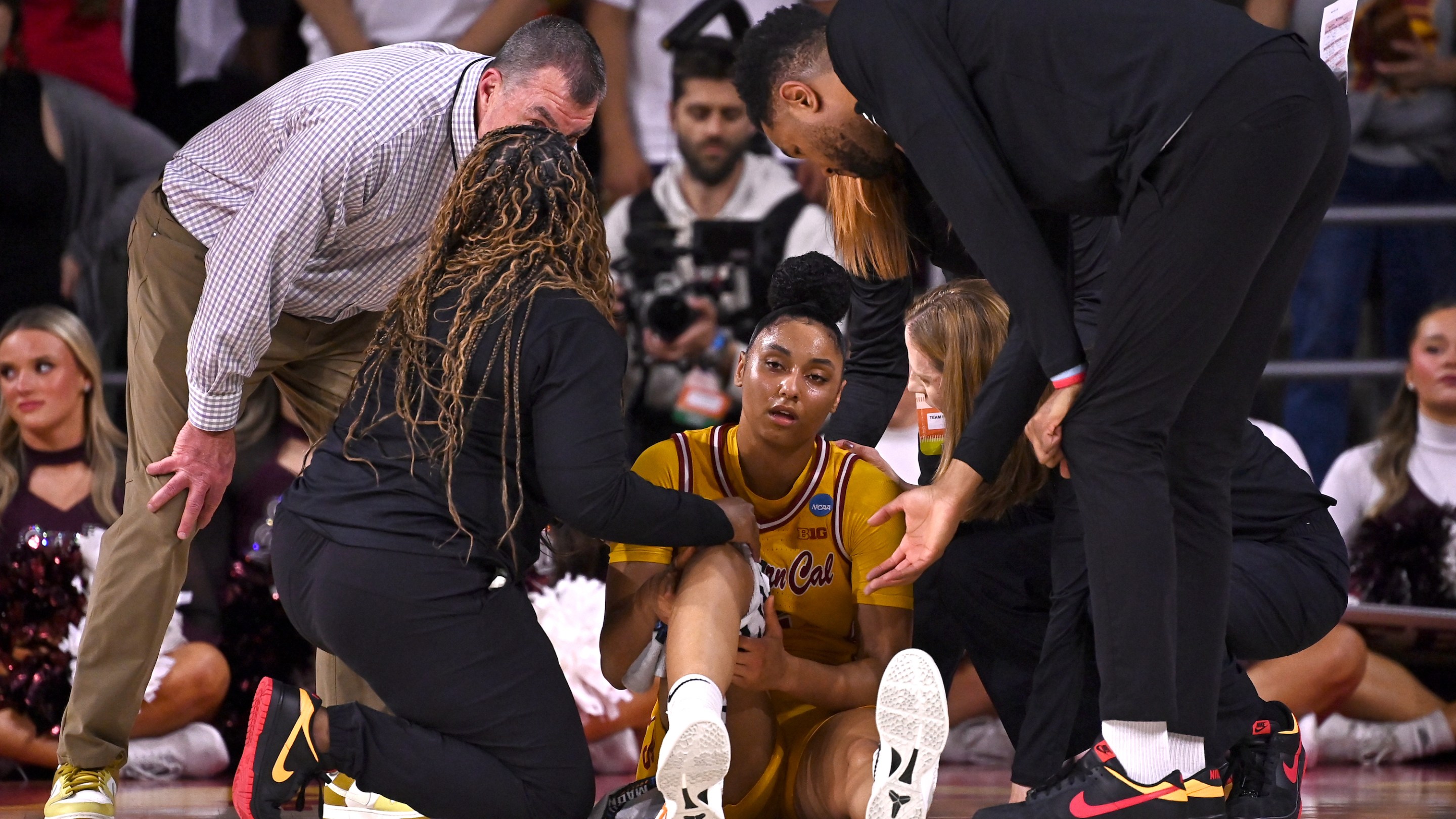 JuJu Watkins #12 of the USC Trojans is attended to by team staff after being injured against the Mississippi State Bulldogs during the Second Round of the 2025 NCAA Women's Basketball Tournament held at Galen Center on March 24, 2025 in Los Angeles, California.