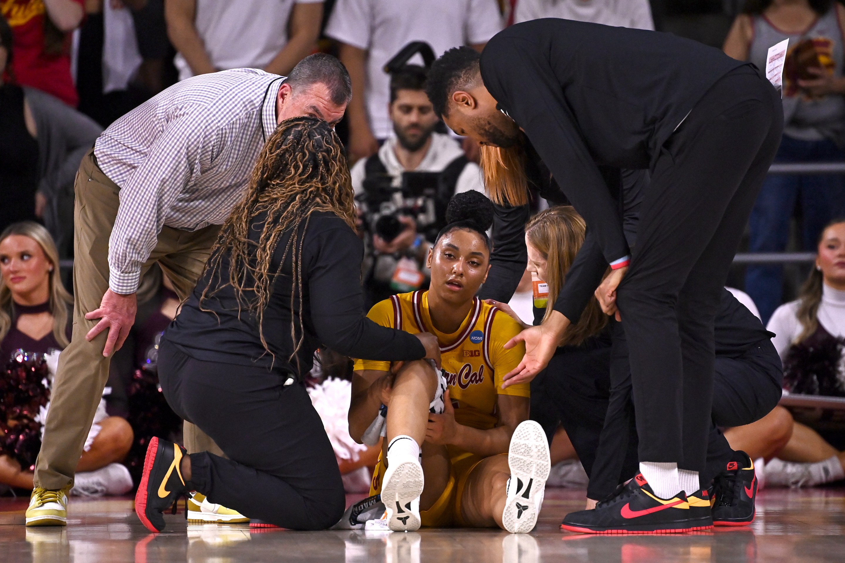 JuJu Watkins #12 of the USC Trojans is attended to by team staff after being injured against the Mississippi State Bulldogs during the Second Round of the 2025 NCAA Women's Basketball Tournament held at Galen Center on March 24, 2025 in Los Angeles, California.