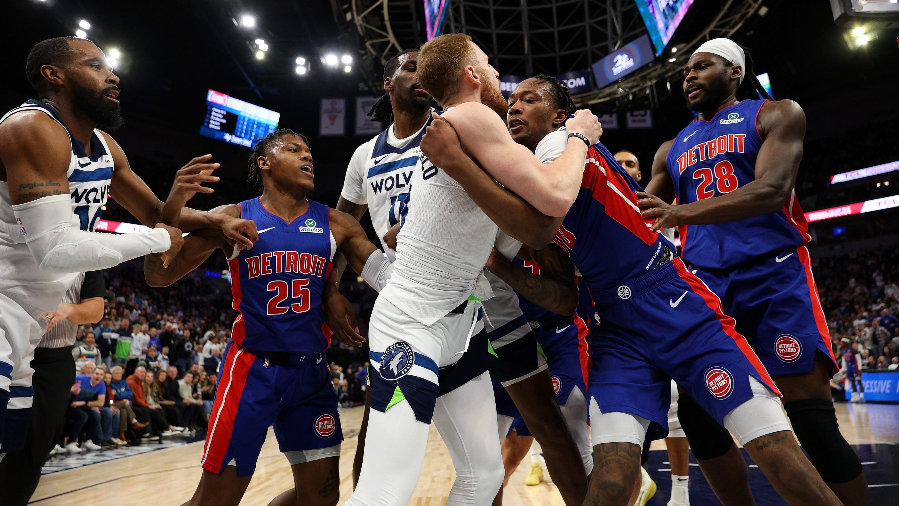 Ronald Holland II #00 of the Detroit Pistons and Donte DiVincenzo #0 of the Minnesota Timberwolves fight in the second quarter. Holland II and DiVincenzo were ejected from the game at Target Center on March 30, 2025 in Minneapolis, Minnesota.