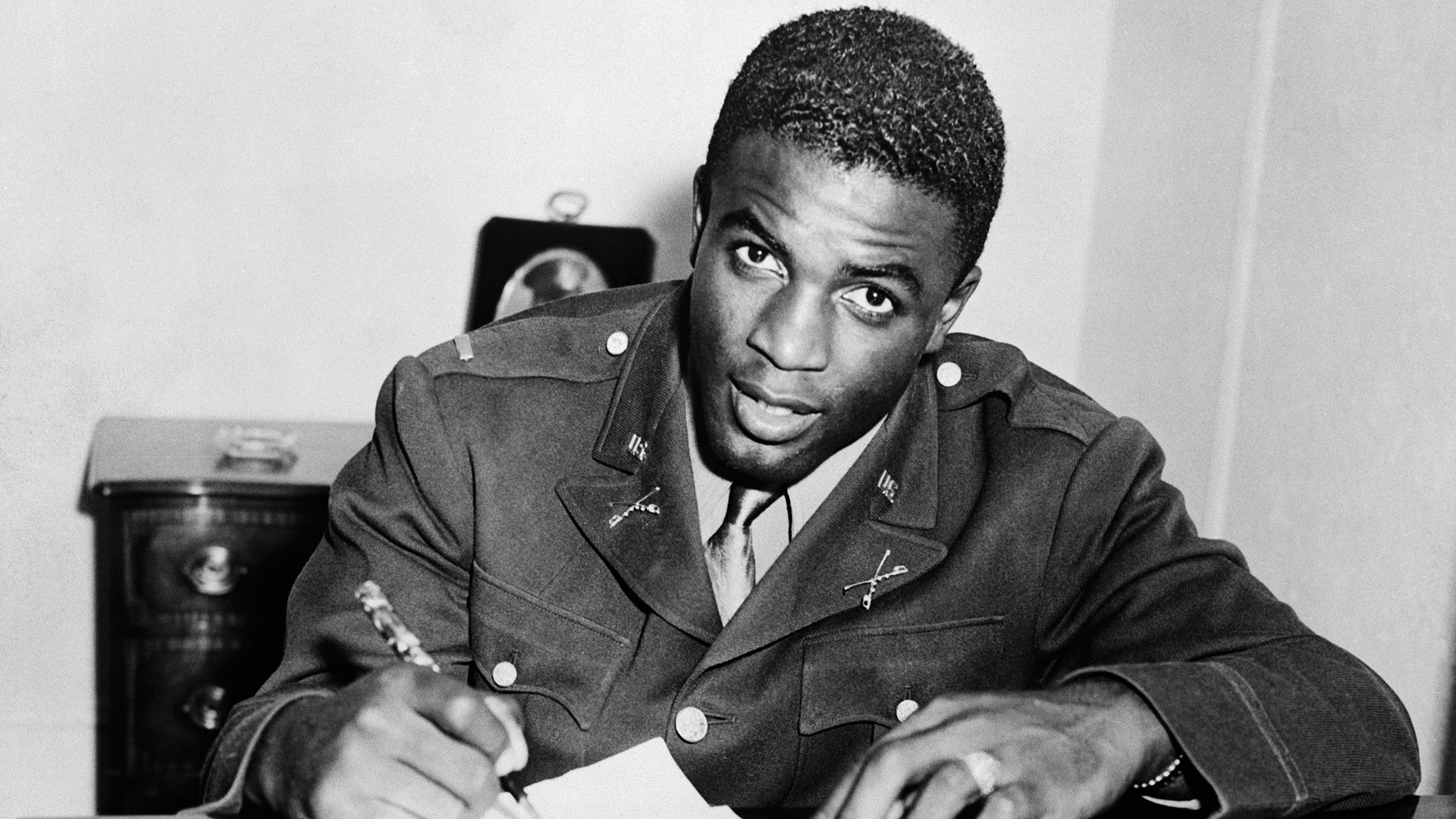 Jackie Robinson, in military uniform, becomes the first African American to sign with a white professional baseball team. He signs a contract with the minor league club in Montreal, a farm team for the Brooklyn Dodgers.