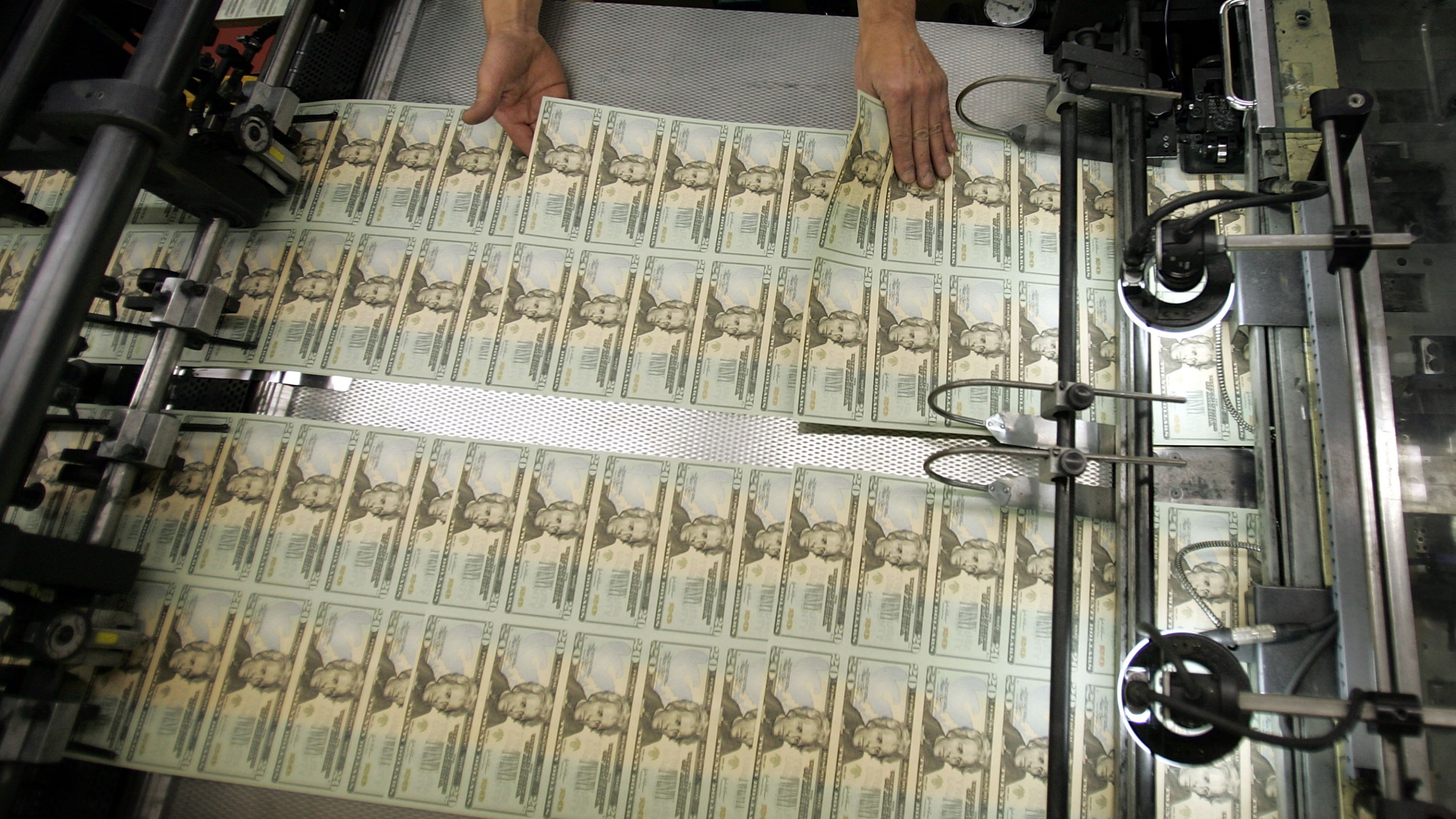 WASHINGTON - APRIL 20: A worker looks for defective bills in the sheets of newly printed twenty dollar bills as they are prepared for distribution to financial institutions April 20, 2005 at the Department of the Treasury Bureau of Engraving and Printing in Washington, DC. Regardless of its denomination, a bill, or banknote, costs 6 cents to produce. A dollar bill lasts about 22 months. (Photo by Joe Raedle/Getty Images)