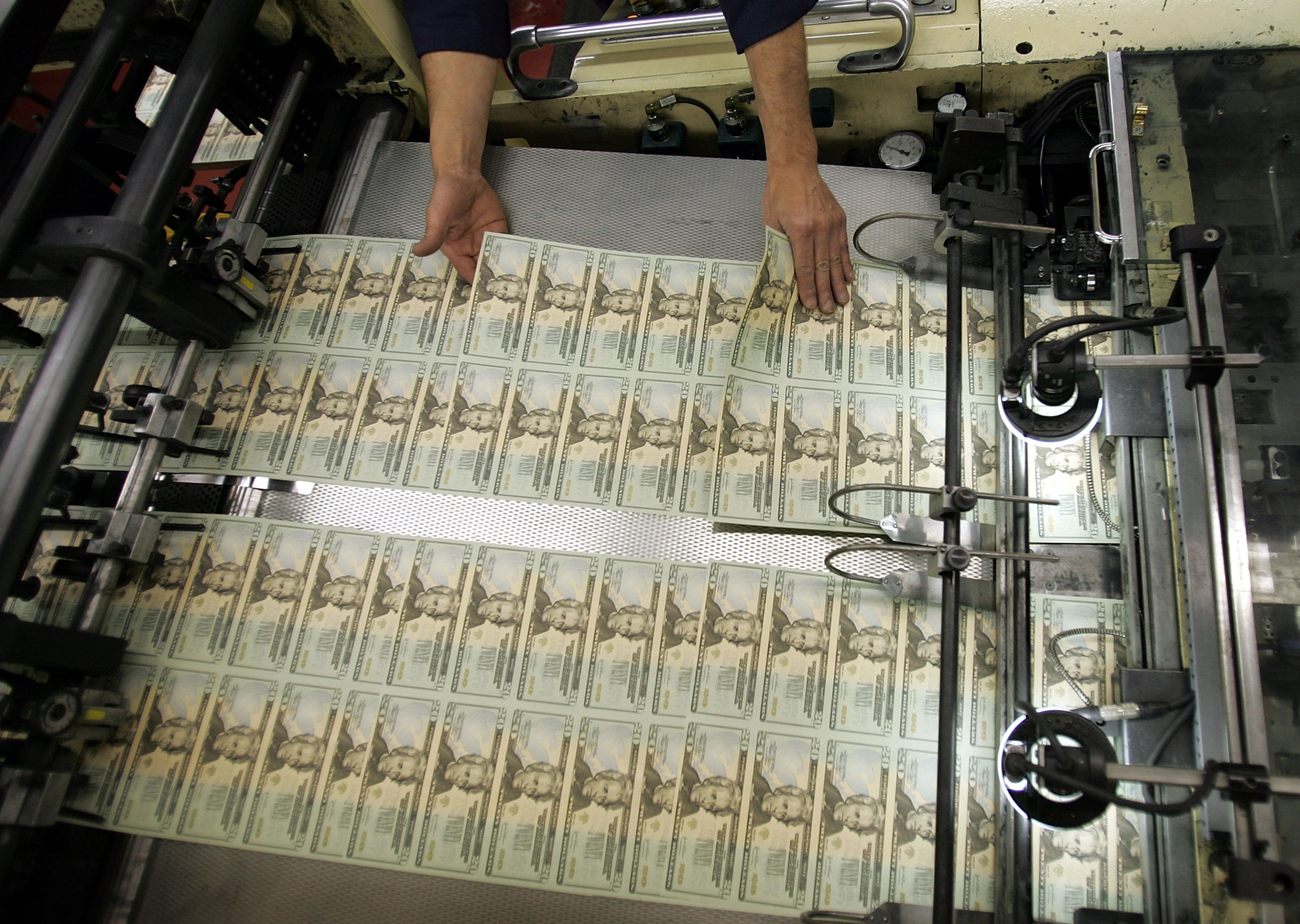 WASHINGTON - APRIL 20: A worker looks for defective bills in the sheets of newly printed twenty dollar bills as they are prepared for distribution to financial institutions April 20, 2005 at the Department of the Treasury Bureau of Engraving and Printing in Washington, DC. Regardless of its denomination, a bill, or banknote, costs 6 cents to produce. A dollar bill lasts about 22 months. (Photo by Joe Raedle/Getty Images)