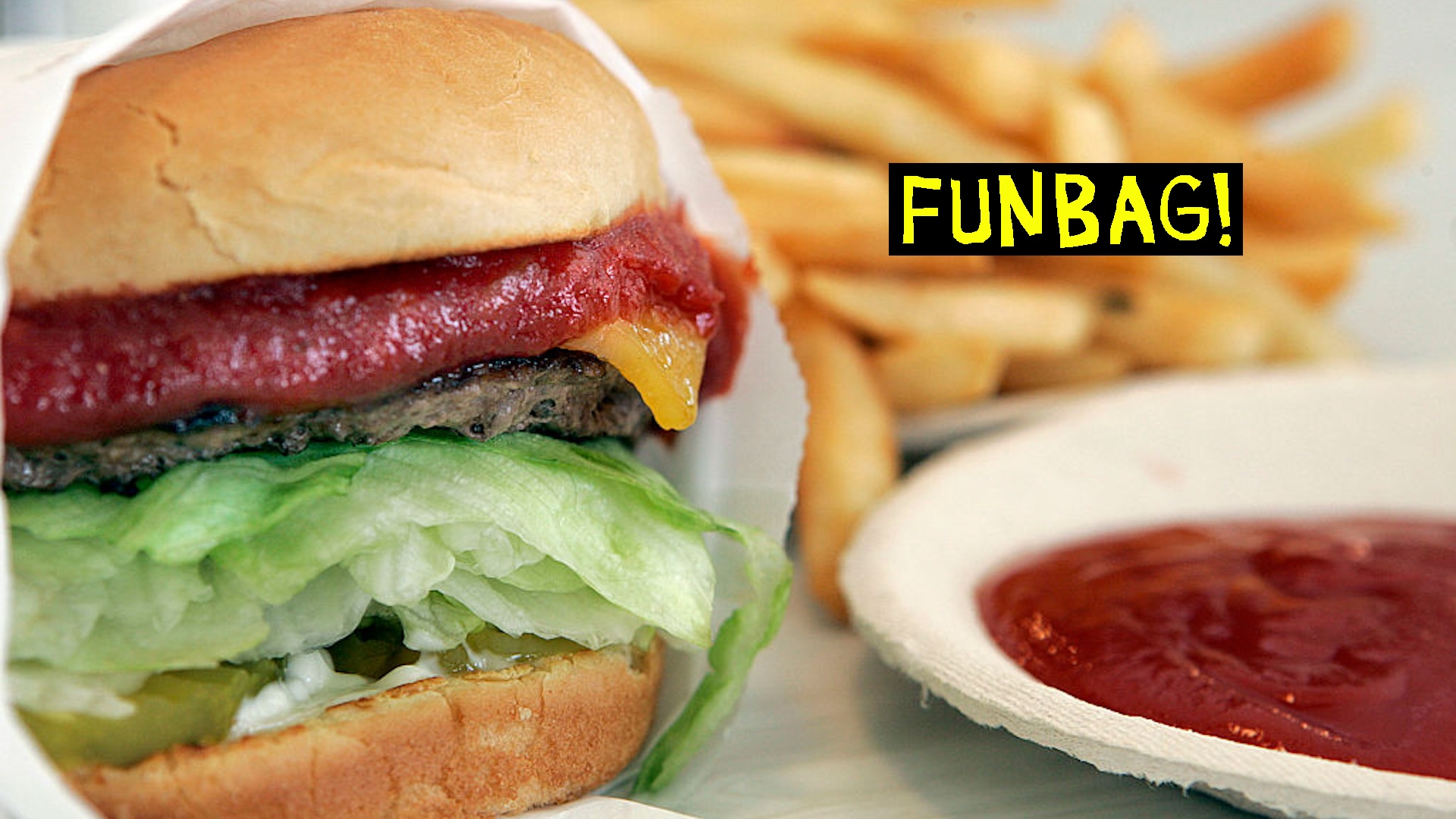 Burger and fries with a plate of ketchup.