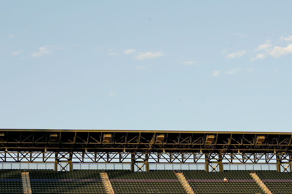A fan sits alone in the purple row of seats that are exactly on mile above sea level during a game between the Houston Astros and Colorado Rockies at Coors Field on August 23, 2011 in Denver, Colorado. The Rockies defeated the Houston Astros 8-6.