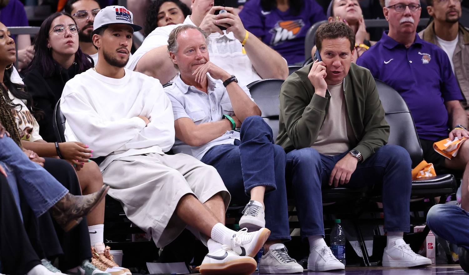 PHOENIX, ARIZONA - JUNE 30: (L-R) Phoenix Suns player Devin Booker, Phoenix Suns head coach Mike Budenholzer and owner Mat Ishbia attend the game between the Phoenix Mercury and the Indiana Fever at Footprint Center on June 30, 2024 in Phoenix, Arizona. The Fever defeated the Mercury 88-82. NOTE TO USER: User expressly acknowledges and agrees that, by downloading and or using this photograph, User is consenting to the terms and conditions of the Getty Images License Agreement. (Photo by Chris Coduto/Getty Images)