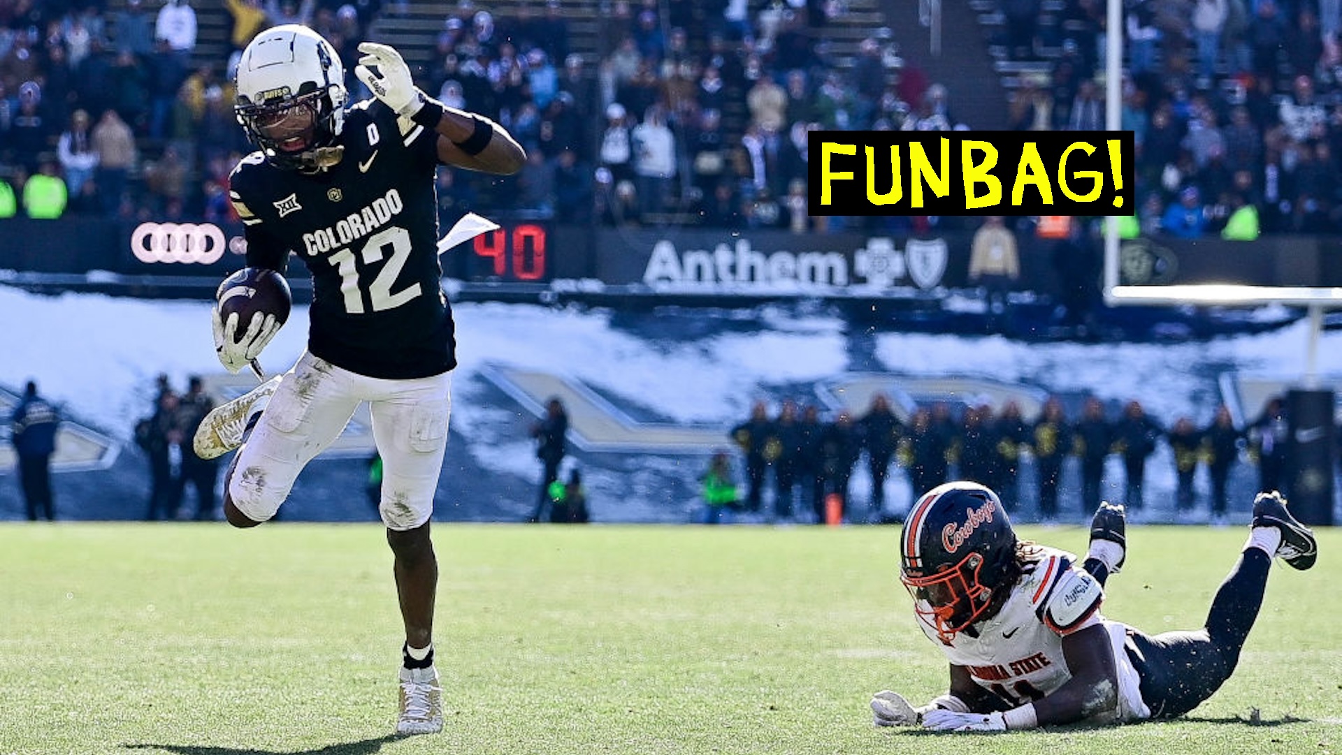 Travis Hunter #12 of the Colorado Buffaloes runs away from a tackle attempt by Dylan Smith #11 of the Oklahoma State Cowboys after a catch in the third quarter at Folsom Field on November 29, 2024 in Boulder, Colorado.