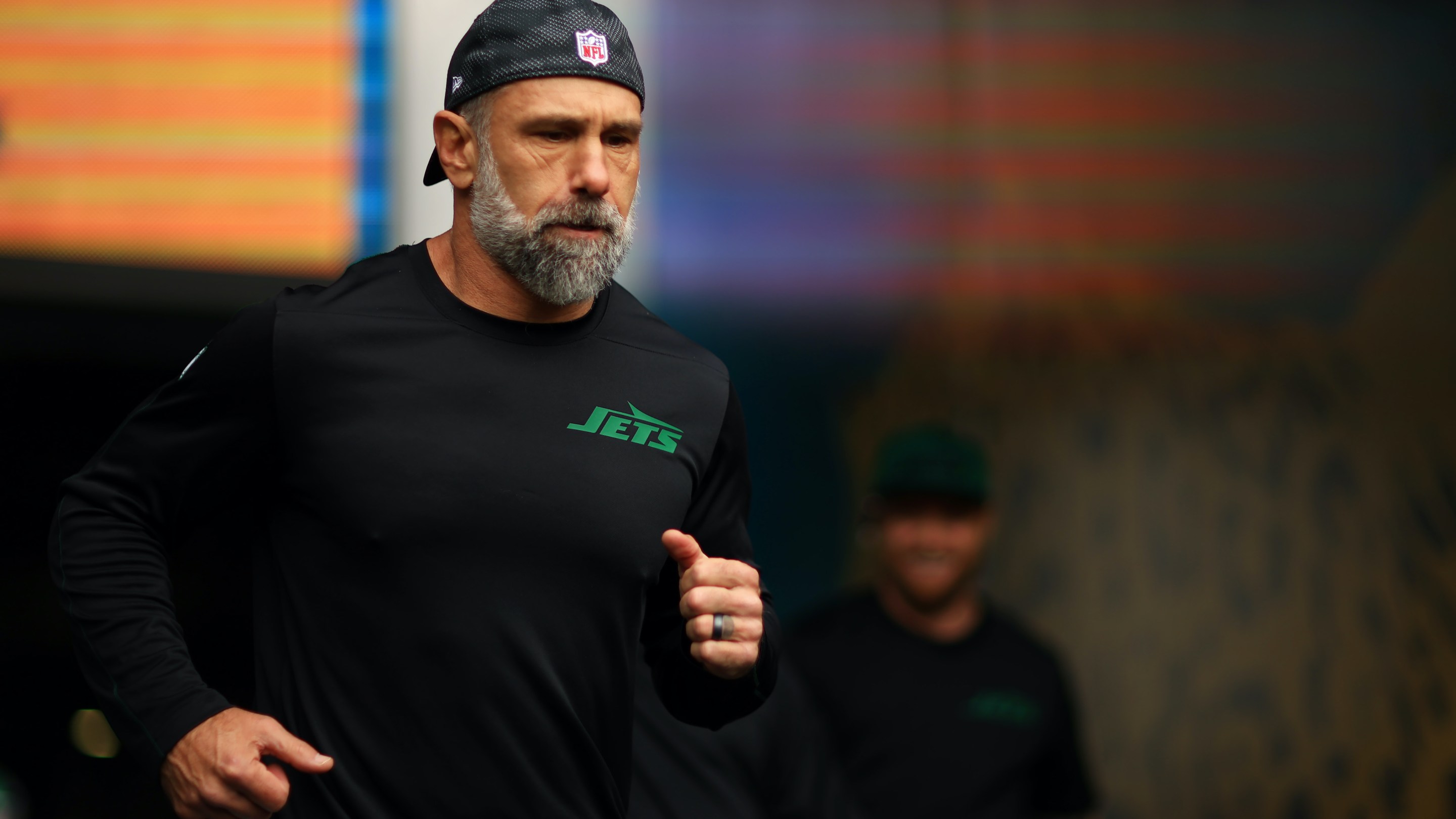 NFL coach Jeff Ulbrich jogging out of the tunnel.