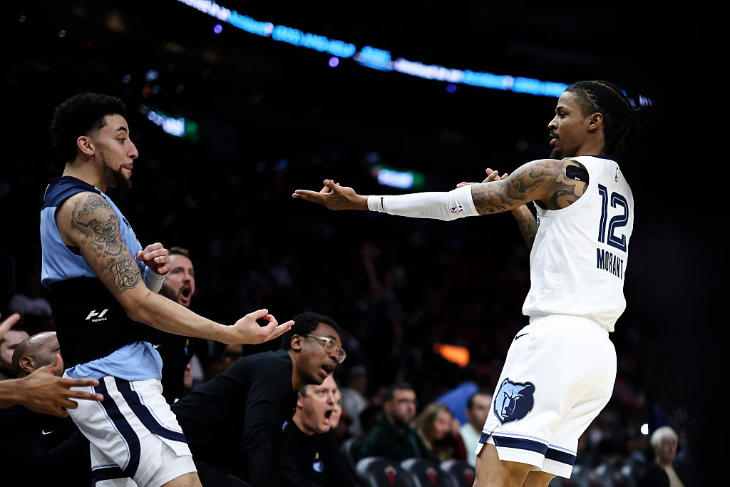 Ja Morant (R #12 of the Memphis Grizzlies reacts with teammate Scotty Pippen Jr. #1 during the third quarter against the Miami Heat at Kaseya Center on April 03, 2025 in Miami, Florida. NOTE TO USER: User expressly acknowledges and agrees that, by downloading and or using this photograph, User is consenting to the terms and conditions of the Getty Images License Agreement.