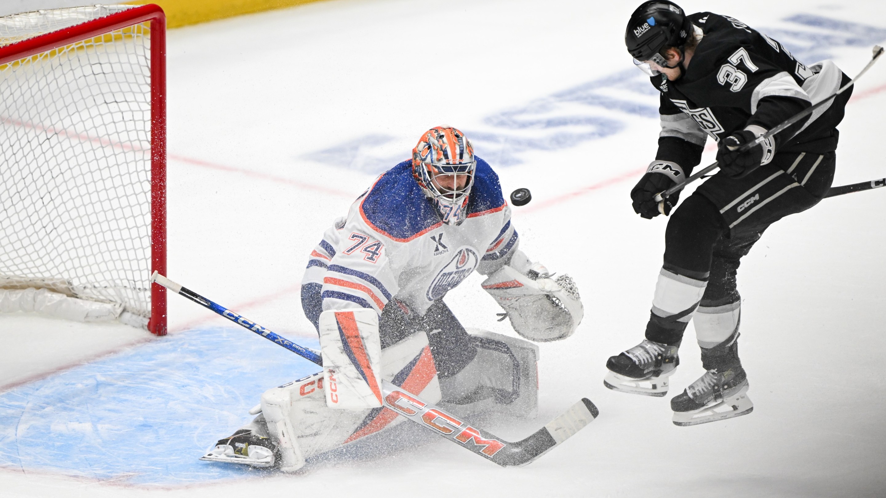 Los Angeles, CA - April 21:Kings Warren Foegele, #37, jumps out of the way of a shot by Kings Phillip Danault, #24, to score past Oilers goalie Stuart Skinner in the final seconds of the third period in Game 1 of the first-round series at Cypto.com Arena on Monday, April 21, 2025. The Kings defeated the Oilers 6-1. (Photo by David Crane/MediaNews Group/Los Angeles Daily News via Getty Images)