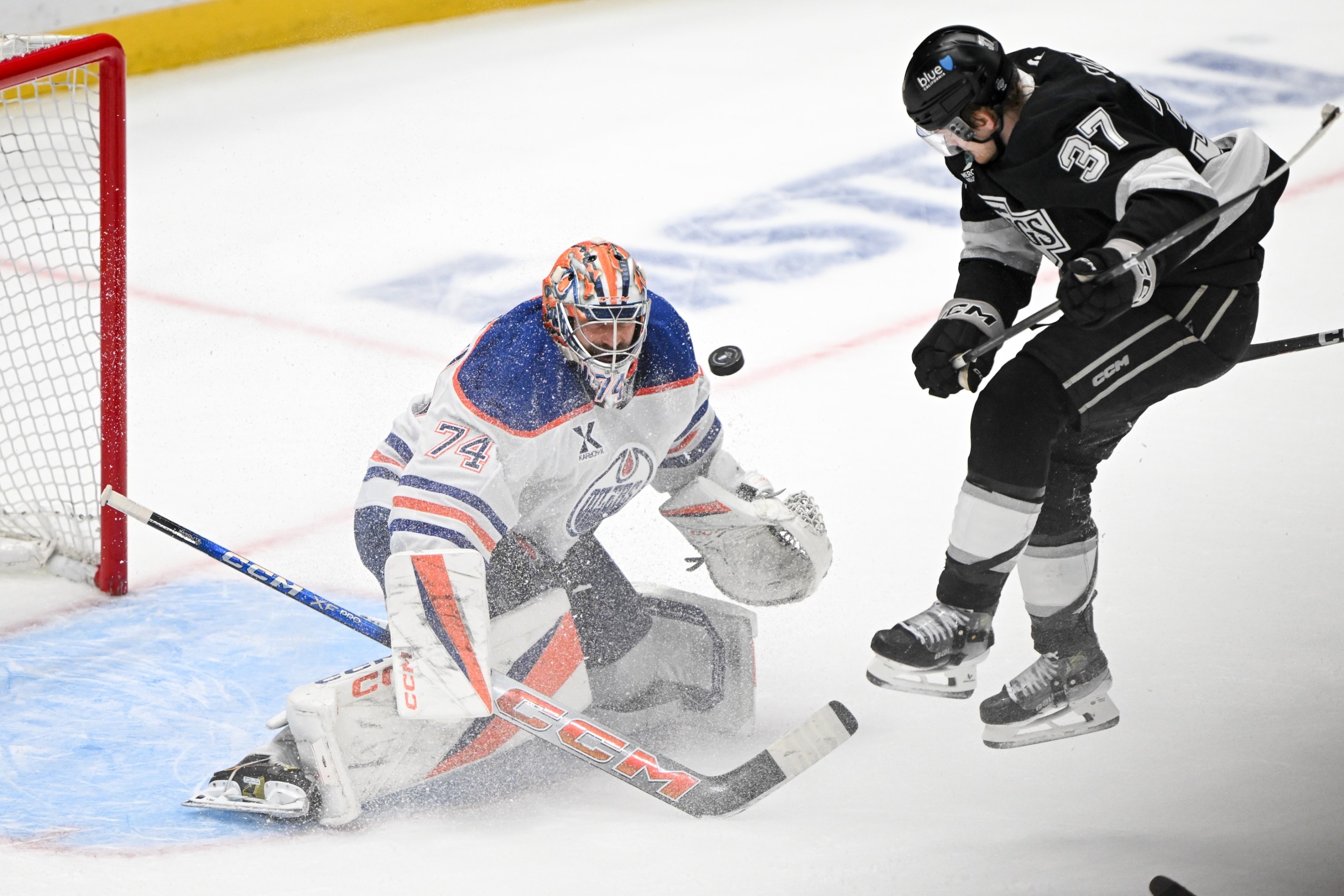 Los Angeles, CA - April 21:Kings Warren Foegele, #37, jumps out of the way of a shot by Kings Phillip Danault, #24, to score past Oilers goalie Stuart Skinner in the final seconds of the third period in Game 1 of the first-round series at Cypto.com Arena on Monday, April 21, 2025. The Kings defeated the Oilers 6-1. (Photo by David Crane/MediaNews Group/Los Angeles Daily News via Getty Images)