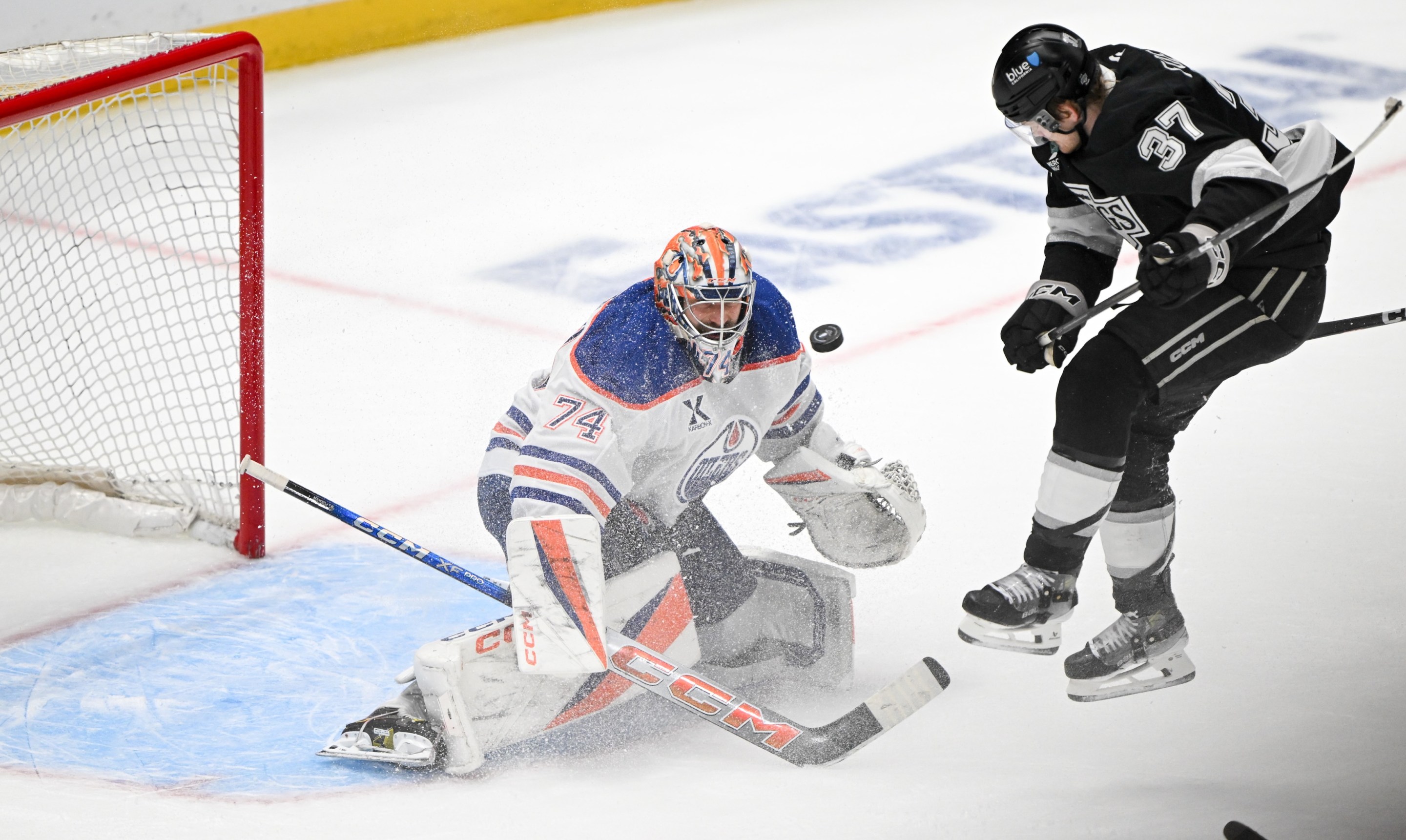 Los Angeles, CA - April 21:Kings Warren Foegele, #37, jumps out of the way of a shot by Kings Phillip Danault, #24, to score past Oilers goalie Stuart Skinner in the final seconds of the third period in Game 1 of the first-round series at Cypto.com Arena on Monday, April 21, 2025. The Kings defeated the Oilers 6-1. (Photo by David Crane/MediaNews Group/Los Angeles Daily News via Getty Images)