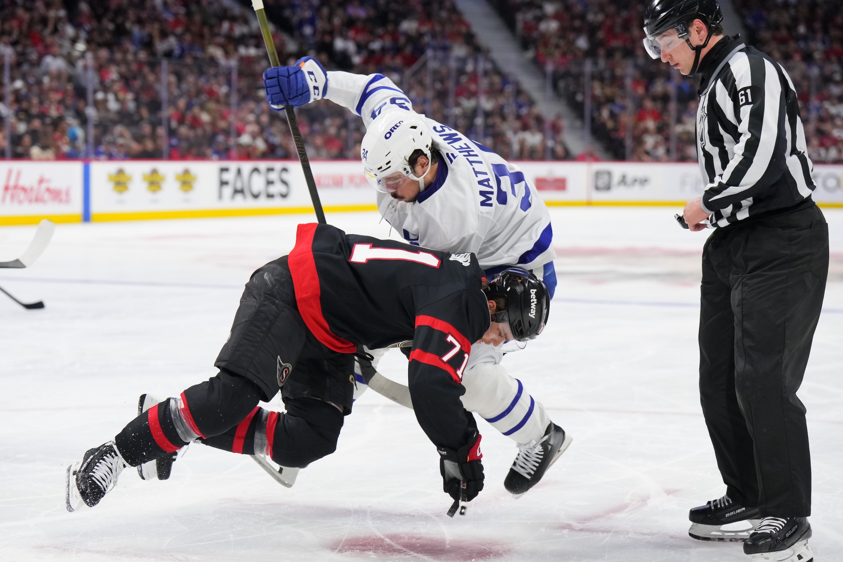 OTTAWA, CANADA - APRIL 24: Ridly Greig #71 of the Ottawa Senators battles for puck possession during a faceoff against Auston Matthews #34 of the Toronto Maple Leafs in the second period of Game Three of the First Round of the 2025 Stanley Cup Playoffs at Canadian Tire Centre on April 24, 2025 in Ottawa, Ontario, Canada. (Photo by André Ringuette/NHLI via Getty Images)
