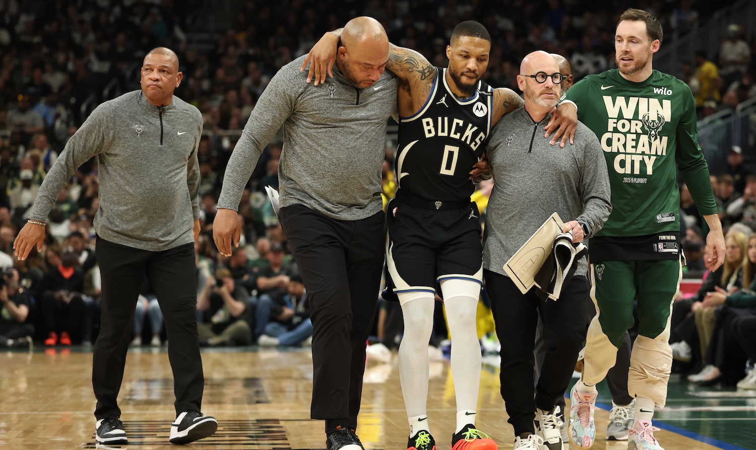 MILWAUKEE, WISCONSIN - APRIL 27: Damian Lillard #0 of the Milwaukee Bucks is helped off the court after an apparent injury during the first quarter in Game Four of the Eastern Conference First Round NBA Playoffs against the Indiana Pacers at Fiserv Forum on April 27, 2025 in Milwaukee, Wisconsin. NOTE TO USER: User expressly acknowledges and agrees that, by downloading and or using this photograph, User is consenting to the terms and conditions of the Getty Images License Agreement. (Photo by Stacy Revere/Getty Images)