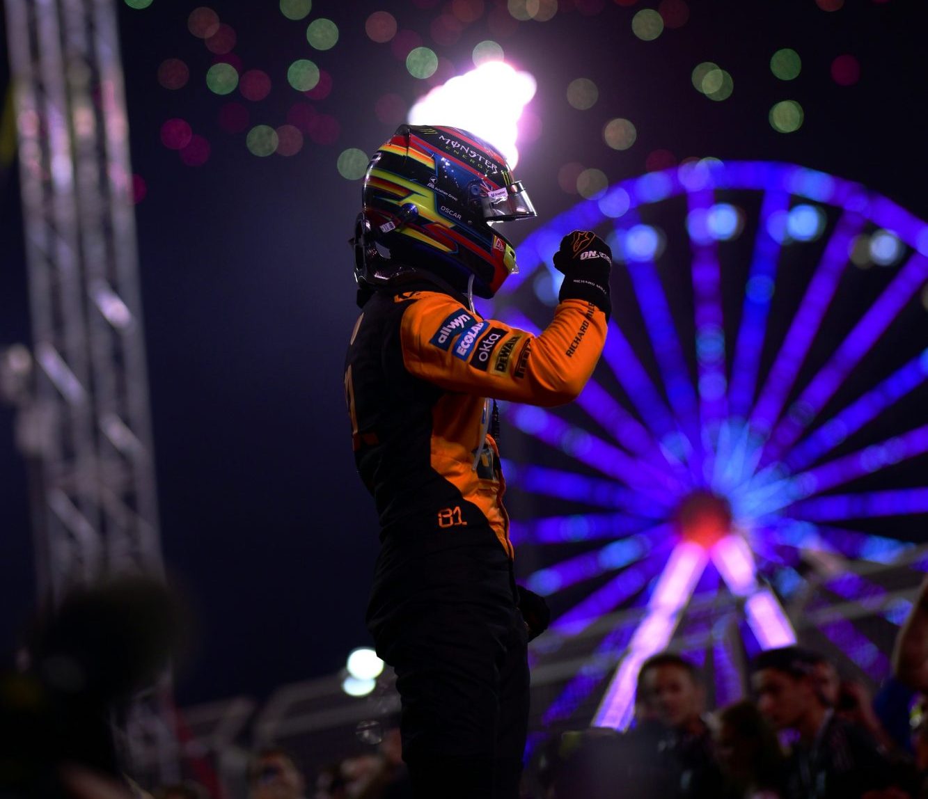 Race winner Oscar Piastri of Australia and McLaren celebrates in parc ferme, surrounded by fireworks.