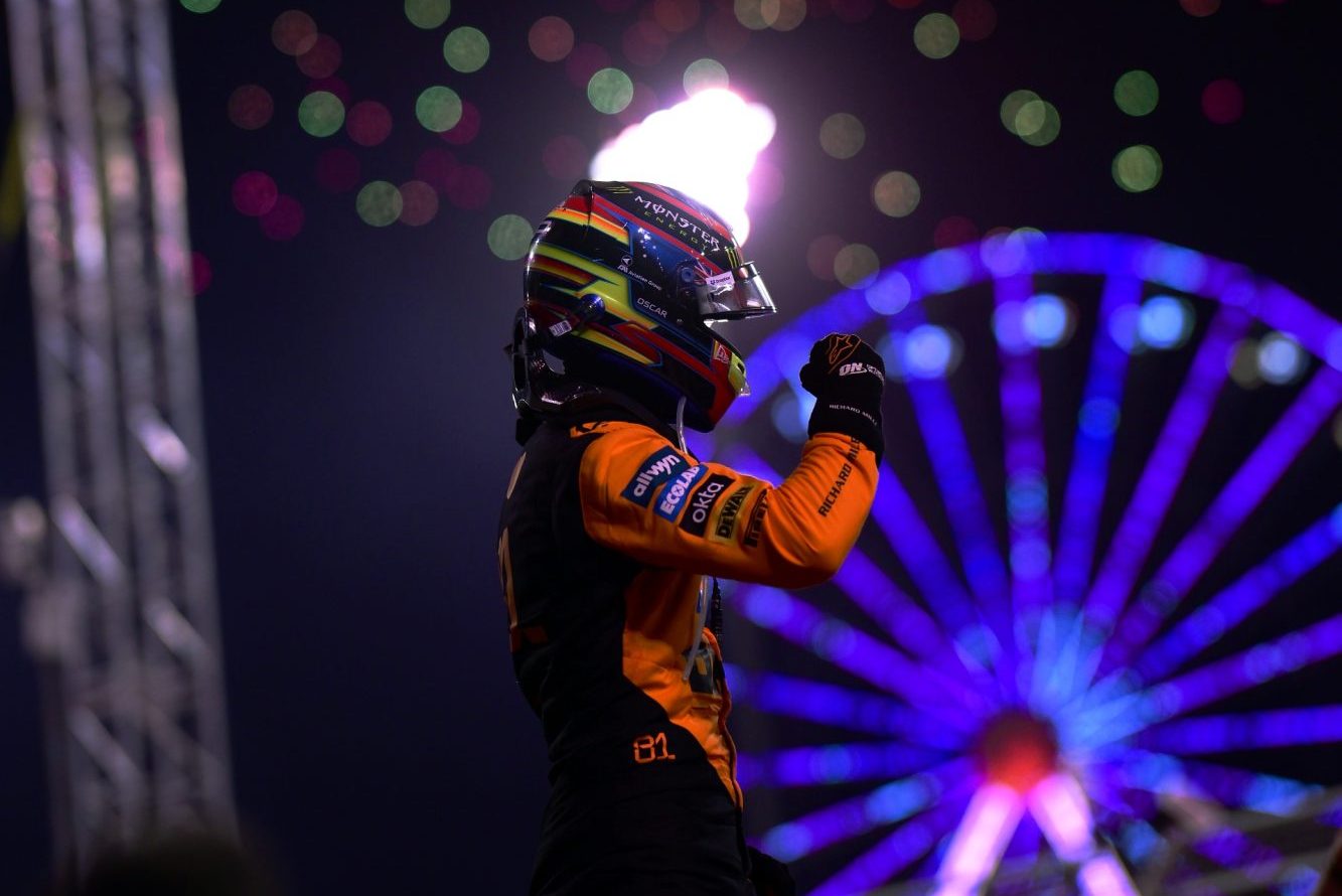 Race winner Oscar Piastri of Australia and McLaren celebrates in parc ferme, surrounded by fireworks.