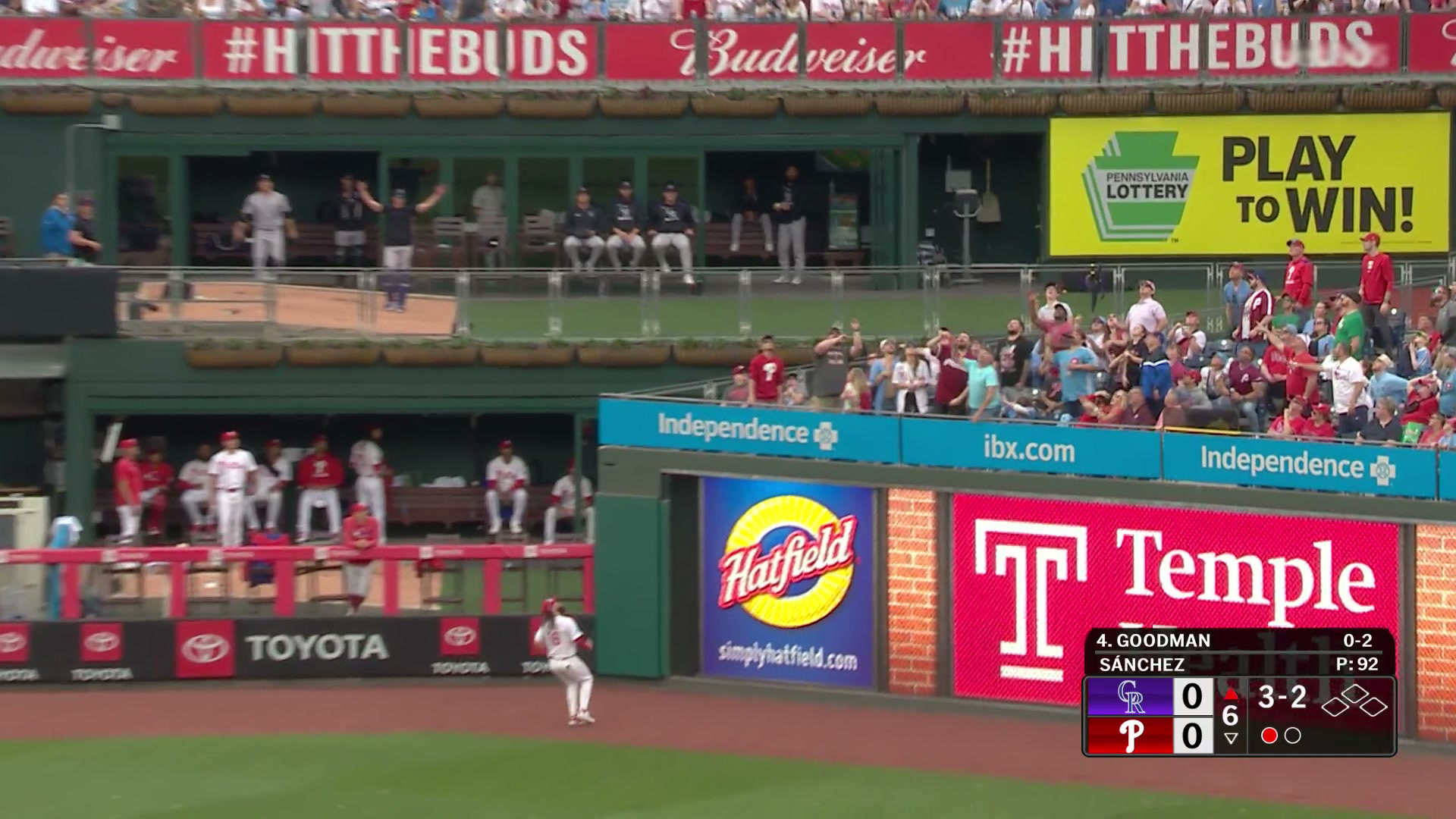 On a homer to right center by the Rockies’ Hunter Goodman, the Phillies and visiting team bullpens are visible on a TV broadcast. Both teams’ bullpens have doors in front of the benches for relievers to sit on, but most of them are open. There are also ads for Hatfield meats, Temple Health, the Pennsylvania Lottery ("Play to win!"), Independence Blue Cross, and Budweiser visible in the shot.