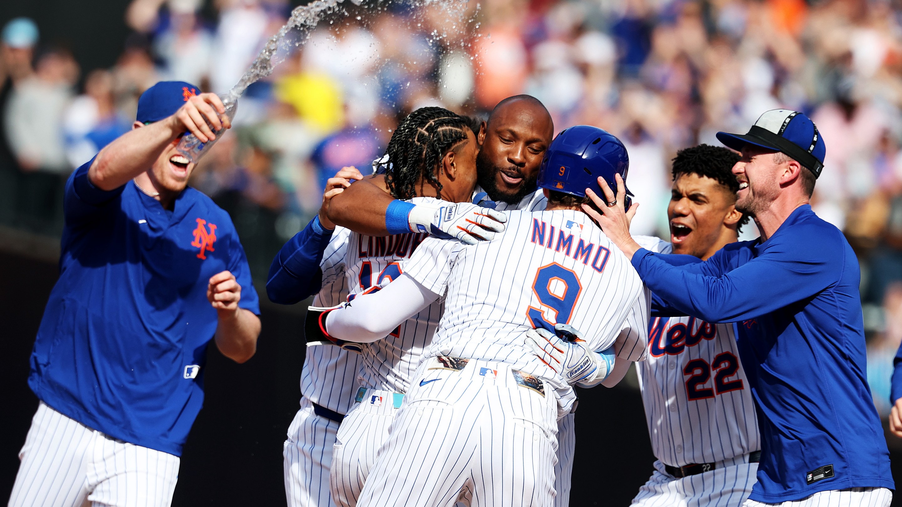 Starling Marte #6 of the New York Mets celebrates with his team after driving in the winning run.