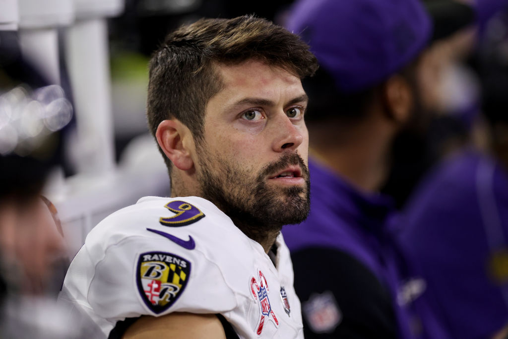 Justin Tucker #9 of the Baltimore Ravens sits on the bench