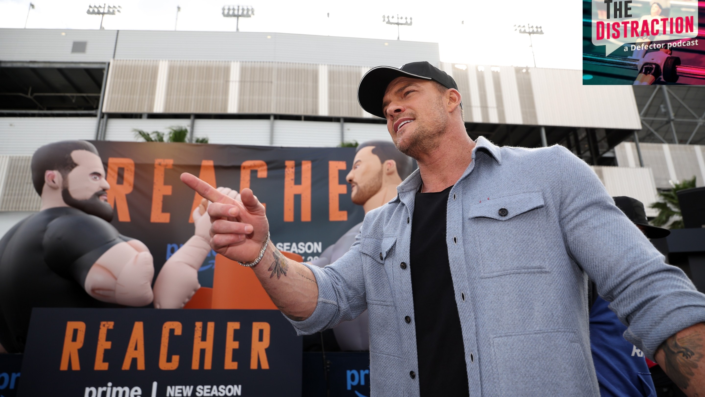 Honorary pace car driver, Alan Ritchson attends the "Reacher" activation on the midway prior to the NASCAR Cup Series Daytona 500 at Daytona International Speedway on February 16, 2025 in Daytona Beach, Florida. The Distraction logo is at upper right.