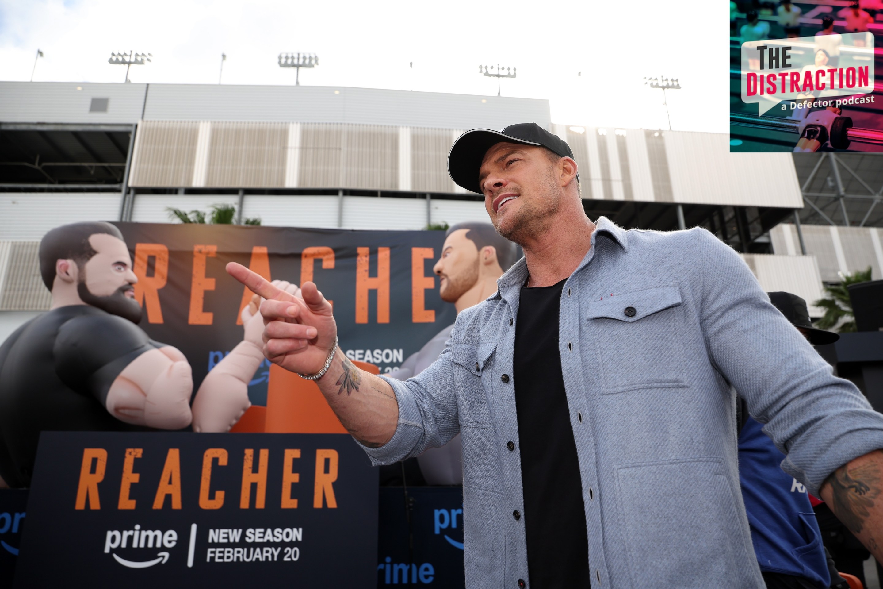 Honorary pace car driver, Alan Ritchson attends the "Reacher" activation on the midway prior to the NASCAR Cup Series Daytona 500 at Daytona International Speedway on February 16, 2025 in Daytona Beach, Florida. The Distraction logo is at upper right.