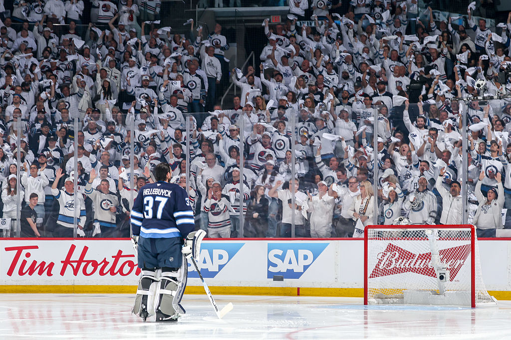 Connor Hellebuyck #37 of the Winnipeg Jets stands on the ice in front of the Whiteout crowd prior to puck drop