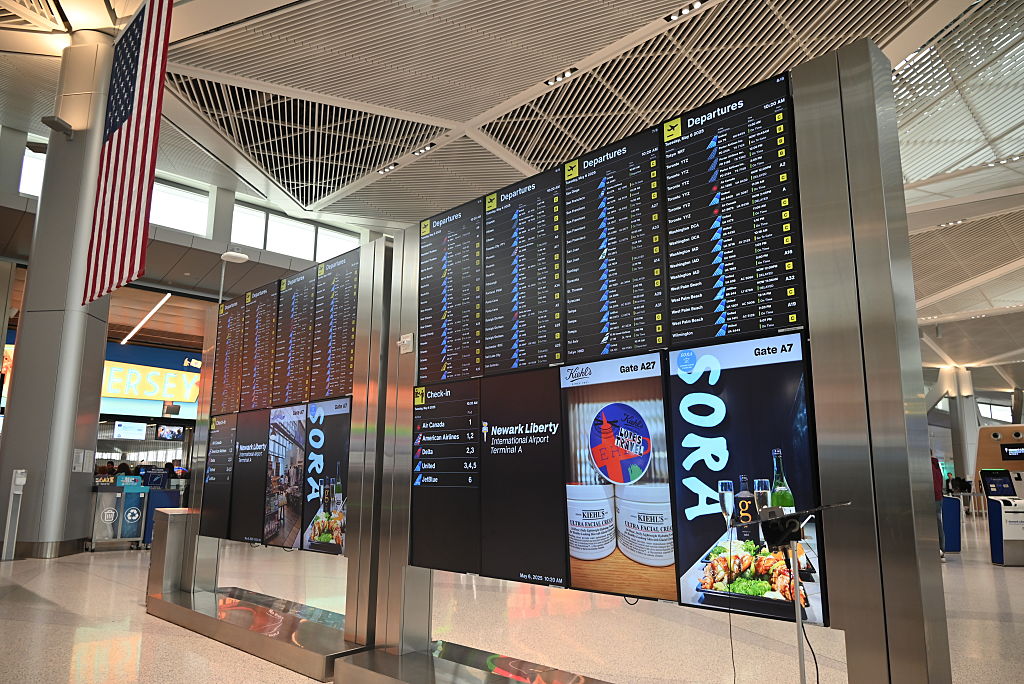 display of flight board inside Newark airport