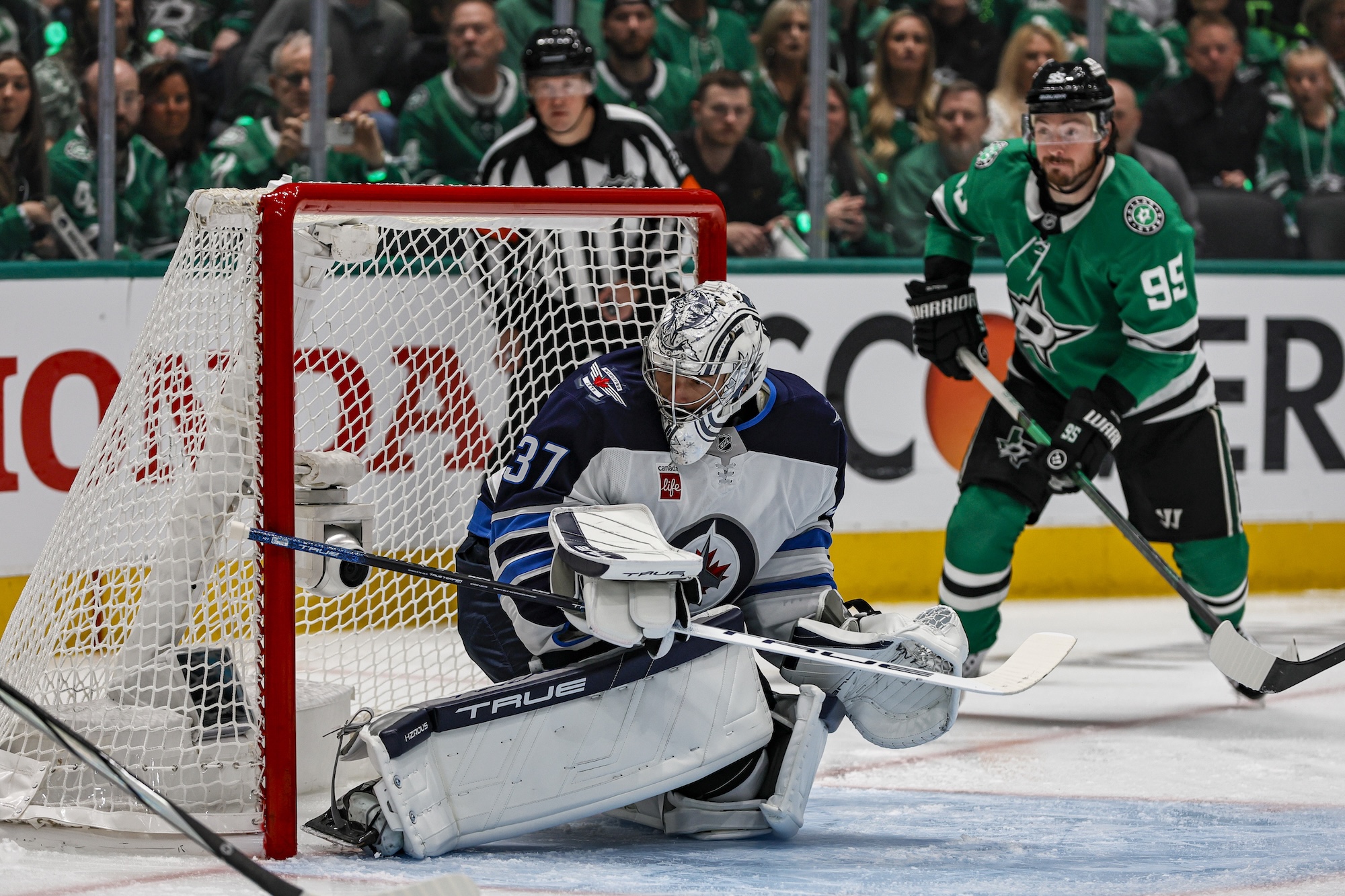 DALLAS, TX - MAY 11: Winnipeg Jets goaltender Connor Hellebuyck (37) tries to block a shot during the game between the Dallas Stars and the Winnipeg Jets on May 11, 2025 at American Airlines Center in Dallas, Texas. (Photo by Matthew Pearce/Icon Sportswire via Getty Images)