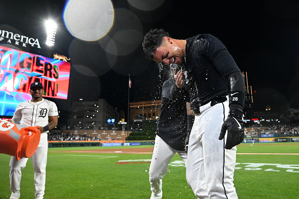 Javier Báez #28 of the Detroit Tigers is showered with ice water after hitting a three-run walk-off home run