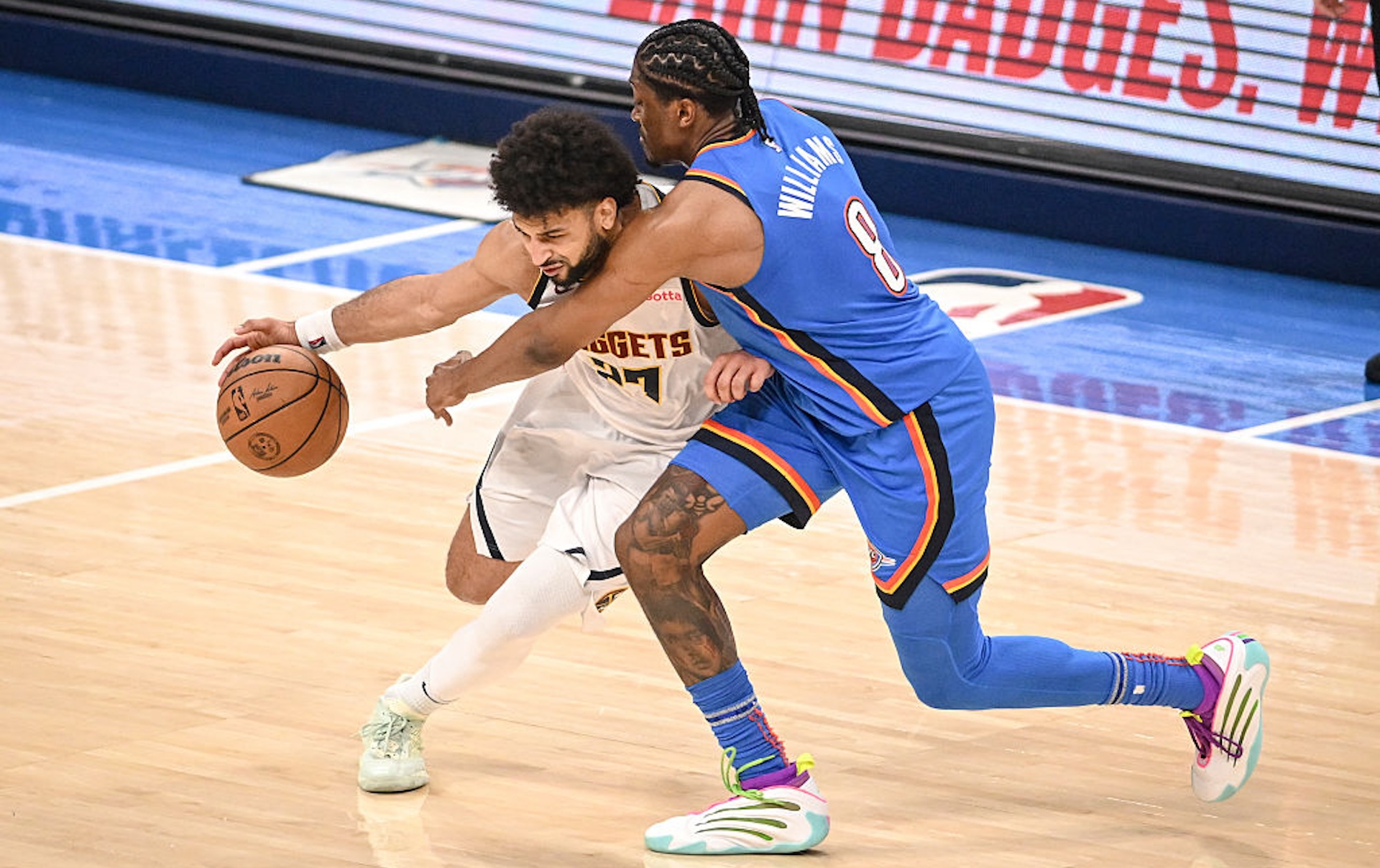 Jalen Williams (8) of the Oklahoma City Thunder guards Jamal Murray (27) of the Denver Nuggets during the third quarter at Paycom Center in Oklahoma City on Sunday, May 18, 2025.