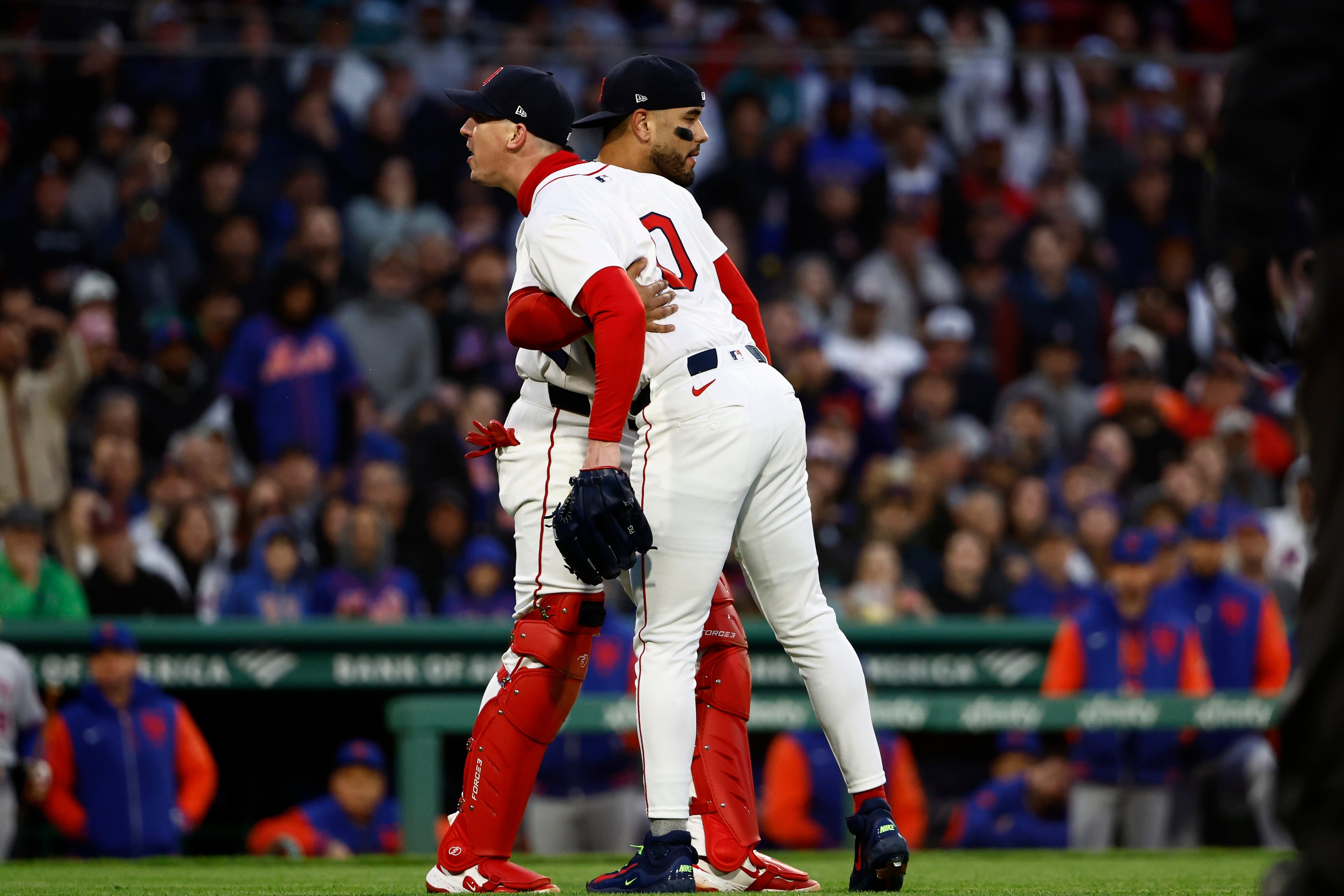 Pitcher Walker Buehler #0 of the Boston Red Sox shouts at home plate umpire Mike Estabrook after a pitch he thought was a strike was called a ball, as Carlos Narváez #75 holds him back during the second inning against the New York Mets at Fenway Park on May 20, 2025 in Boston, Massachusetts. Buehler was thrown out of the game by Estabrook.