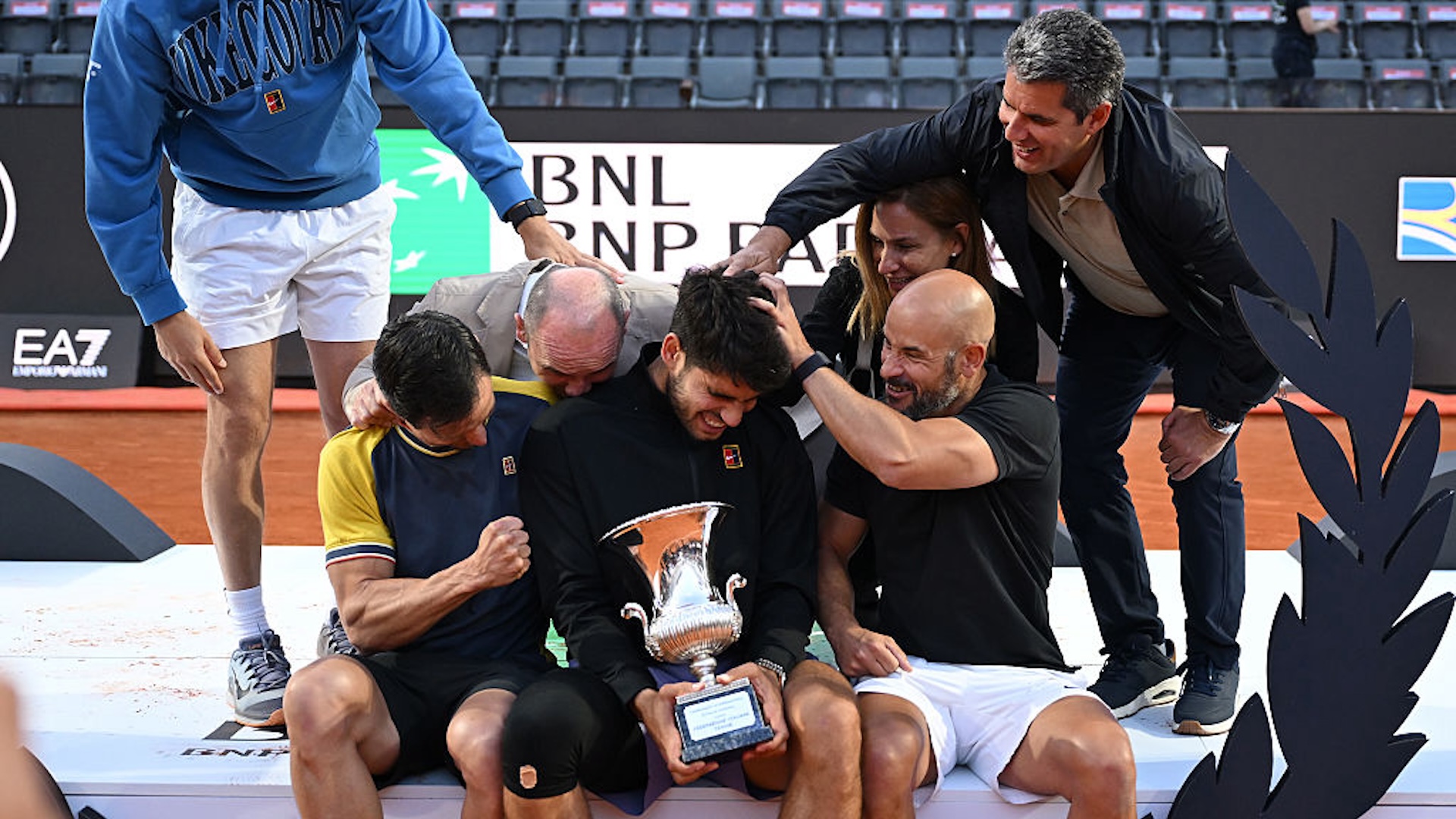 Carlos Alcaraz of Spain poses for a photo with his trophy alongside his team following victory against Jannik Sinner of Italy in the Men's Singles Final match on Day Fourteen of the Internazionali BNL D'Italia 2025 at Foro Italico on May 18, 2025 in Rome, Italy.