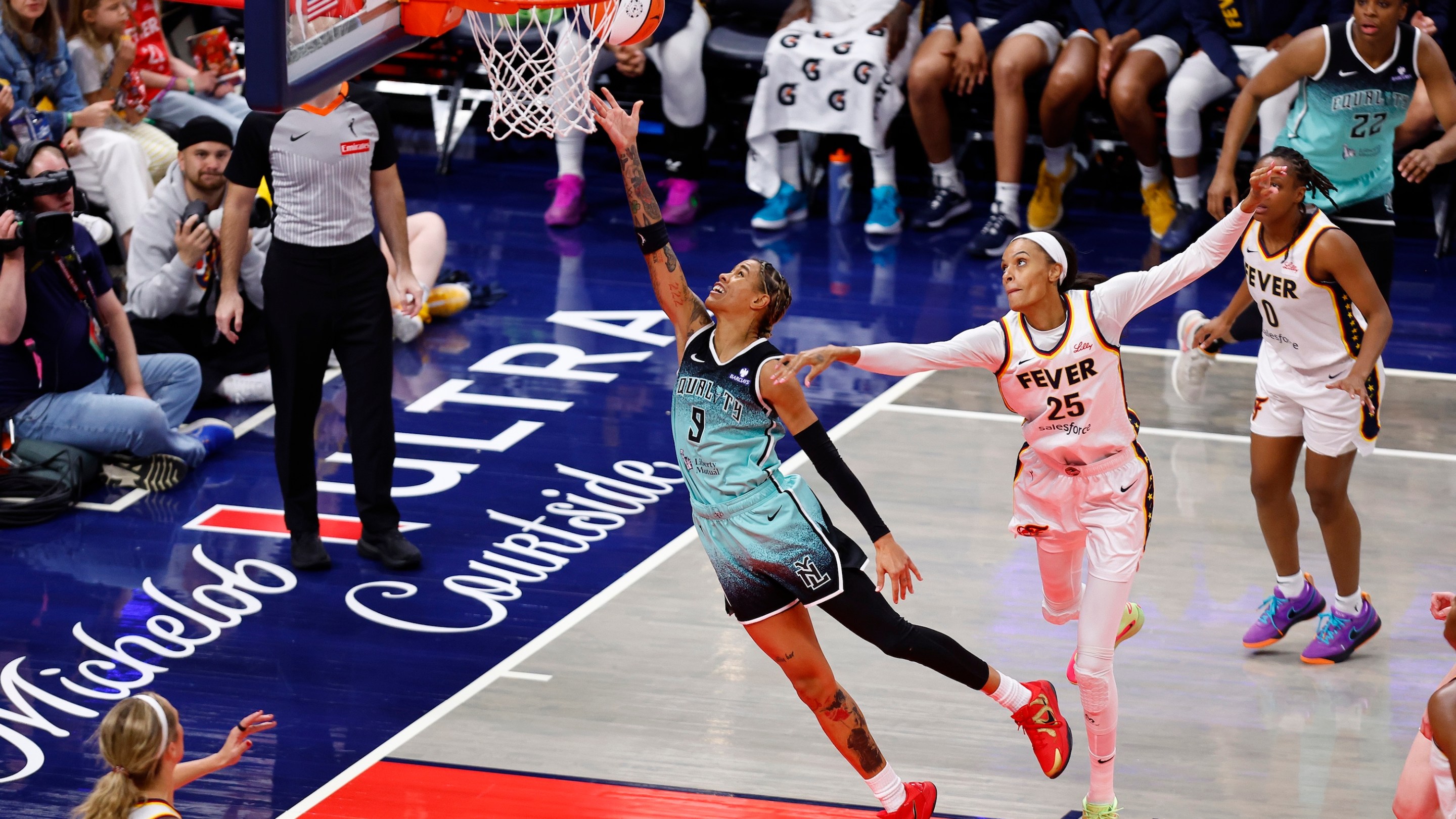 New York Liberty guard Natasha Cloud (9) drives past Indiana Fever forward DeWanna Bonner (25) and goes in for two during a WNBA game between the New York Liberty and the Indiana Fever on May 24, 2025 at Gainbridge Fieldhouse in Indianapolis, IN.