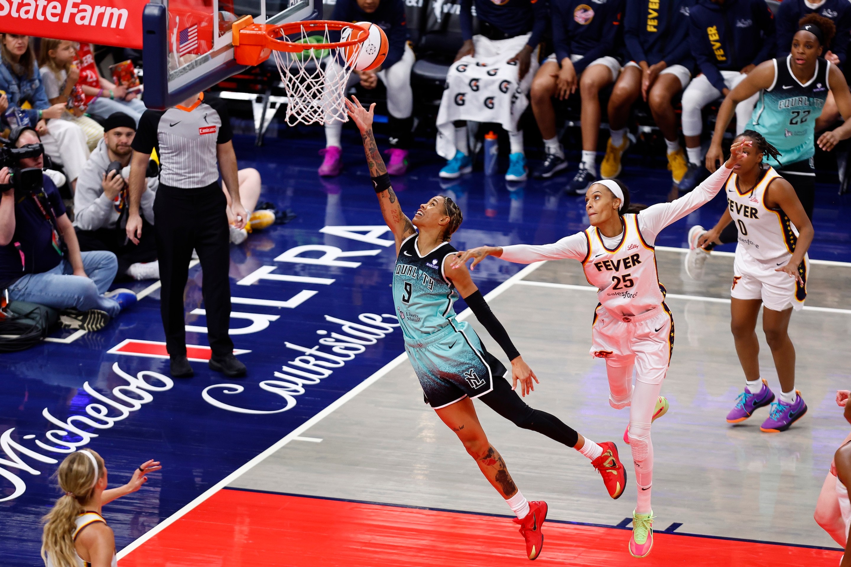 New York Liberty guard Natasha Cloud (9) drives past Indiana Fever forward DeWanna Bonner (25) and goes in for two during a WNBA game between the New York Liberty and the Indiana Fever on May 24, 2025 at Gainbridge Fieldhouse in Indianapolis, IN.