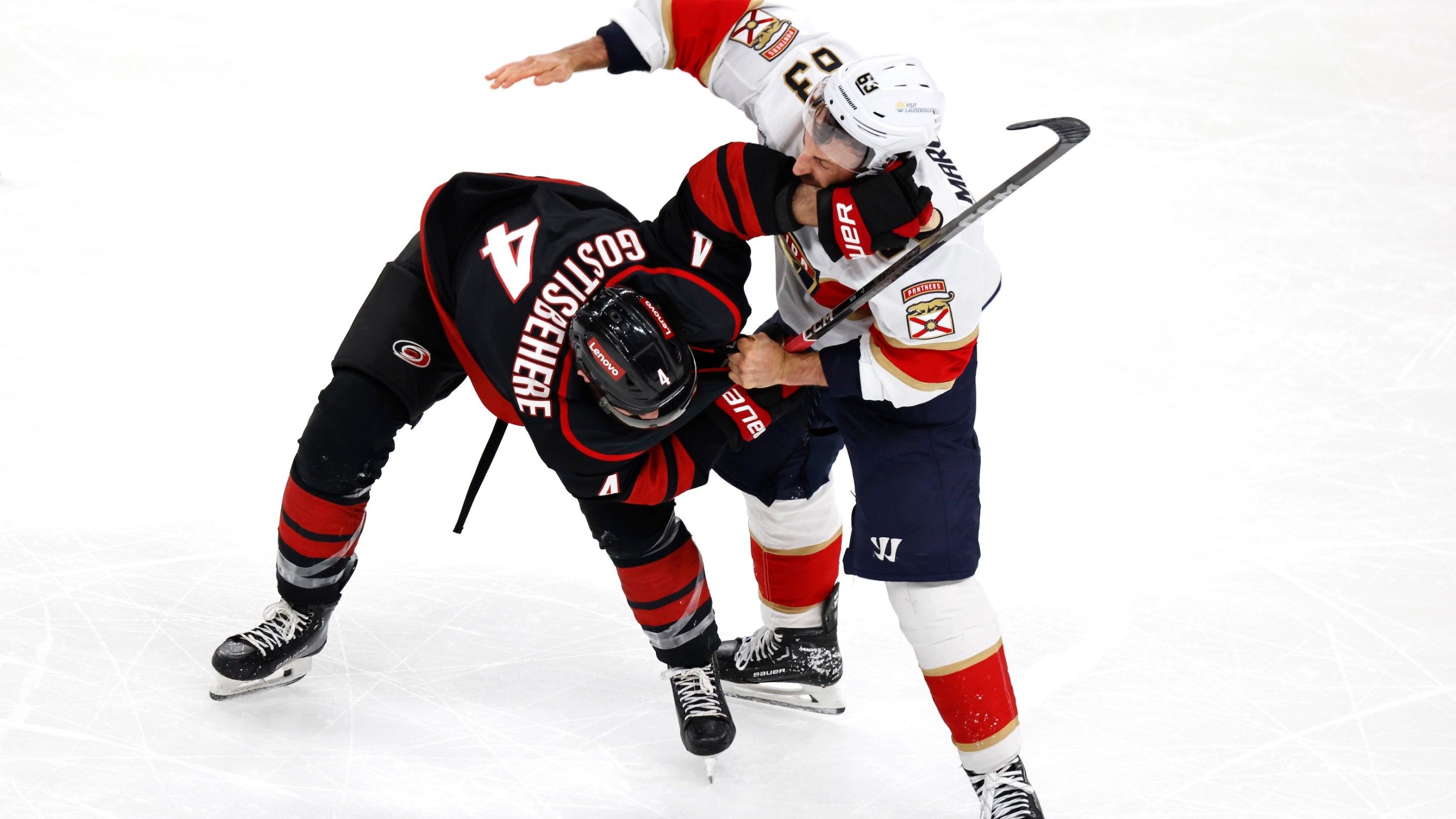 Brad Marchand #63 of the Florida Panthers fights with Shayne Gostisbehere #4 of the Carolina Hurricanes during the third period in Game One of the Eastern Conference Final of the 2025 Stanley Cup Playoffs on May 20, 2025.