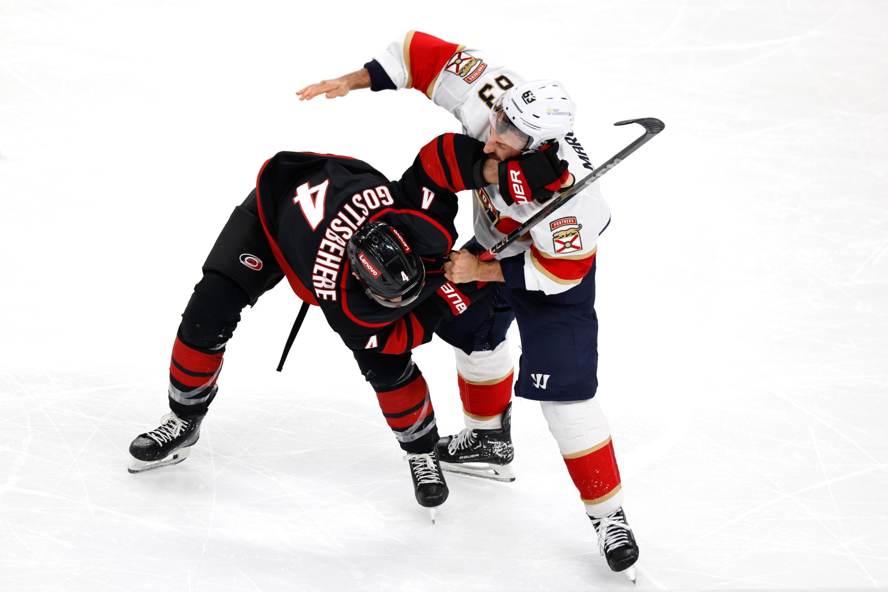Brad Marchand #63 of the Florida Panthers fights with Shayne Gostisbehere #4 of the Carolina Hurricanes during the third period in Game One of the Eastern Conference Final of the 2025 Stanley Cup Playoffs on May 20, 2025.